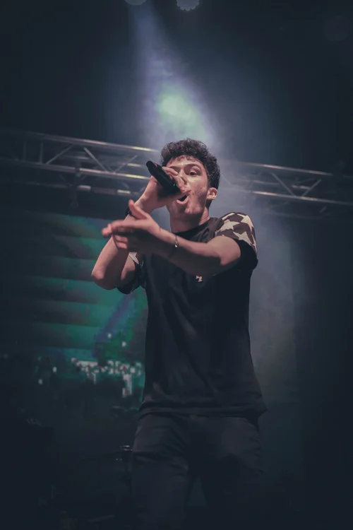 ELAM student performing on stage, pointing to the crowd