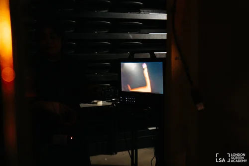 Monitor glowing in a darkened film studio