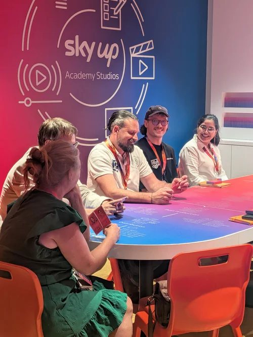 Educators chatting round a table at Sky Up Academy Studios