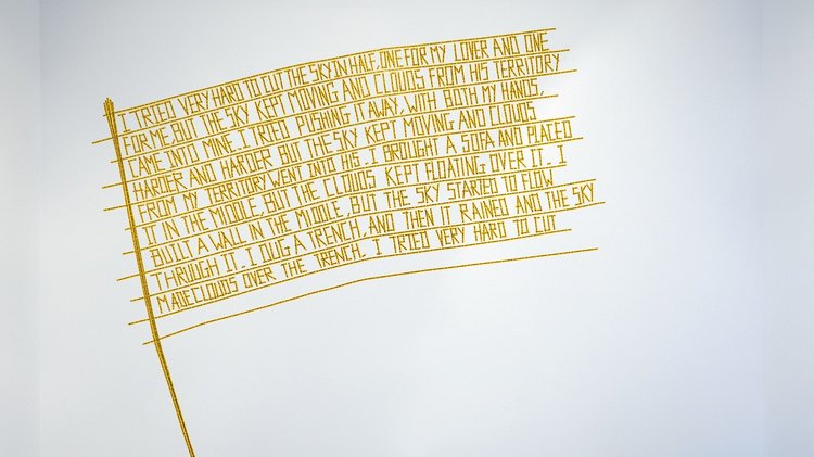 words closely written together in yellow forming the shape of a flag
