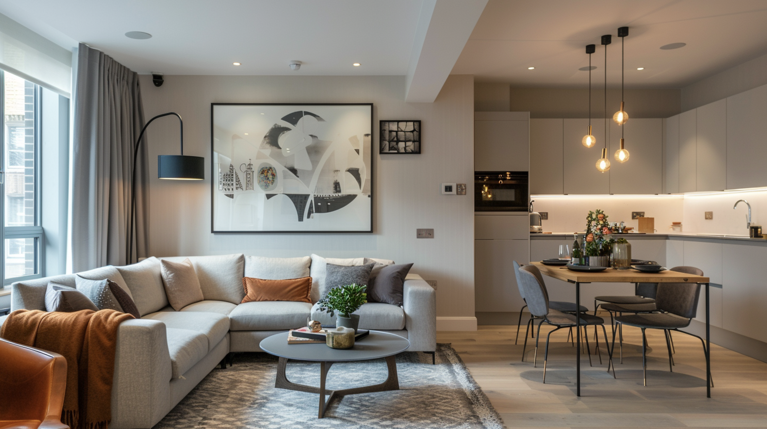 Open-plan small London flat layout with rug zoning and multifunctional dining desk