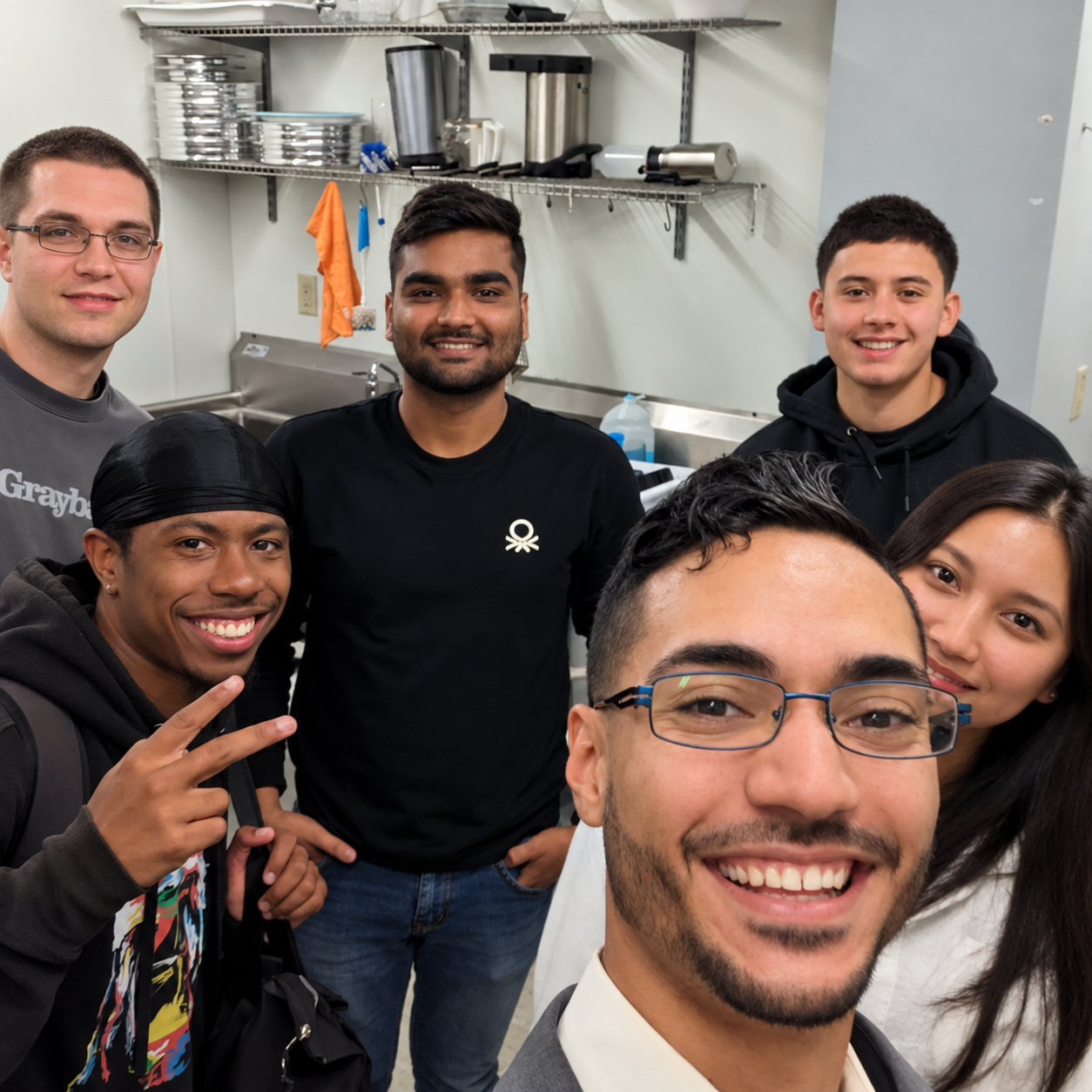 A group of friends and young adults smiling together during church fellowship
