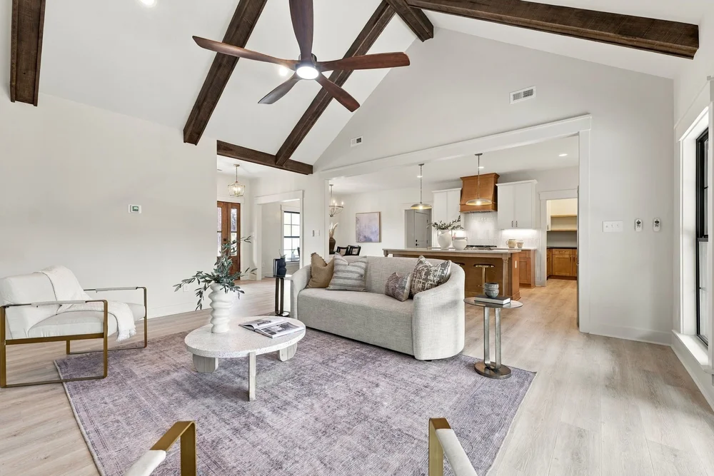 Open great room with vaulted beamed ceiling looking toward the kitchen