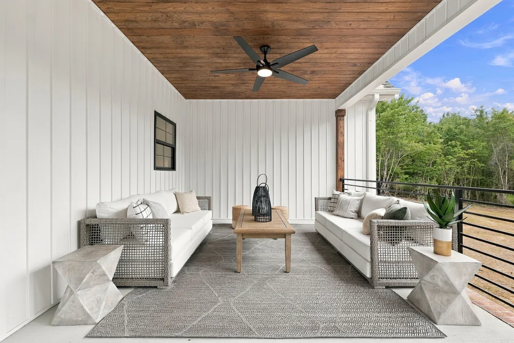 Covered rear porch with a wood ceiling, fan and seating