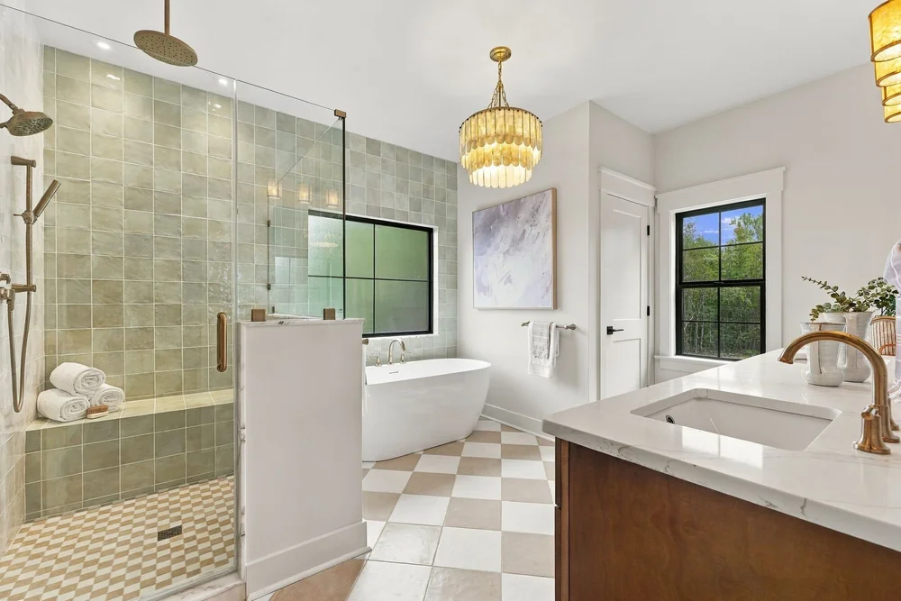 Primary bath with a tiled walk-in shower and double vanity