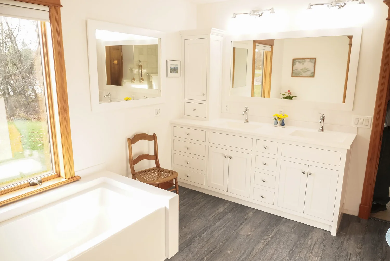 White bathroom with a soaking tub and double vanity