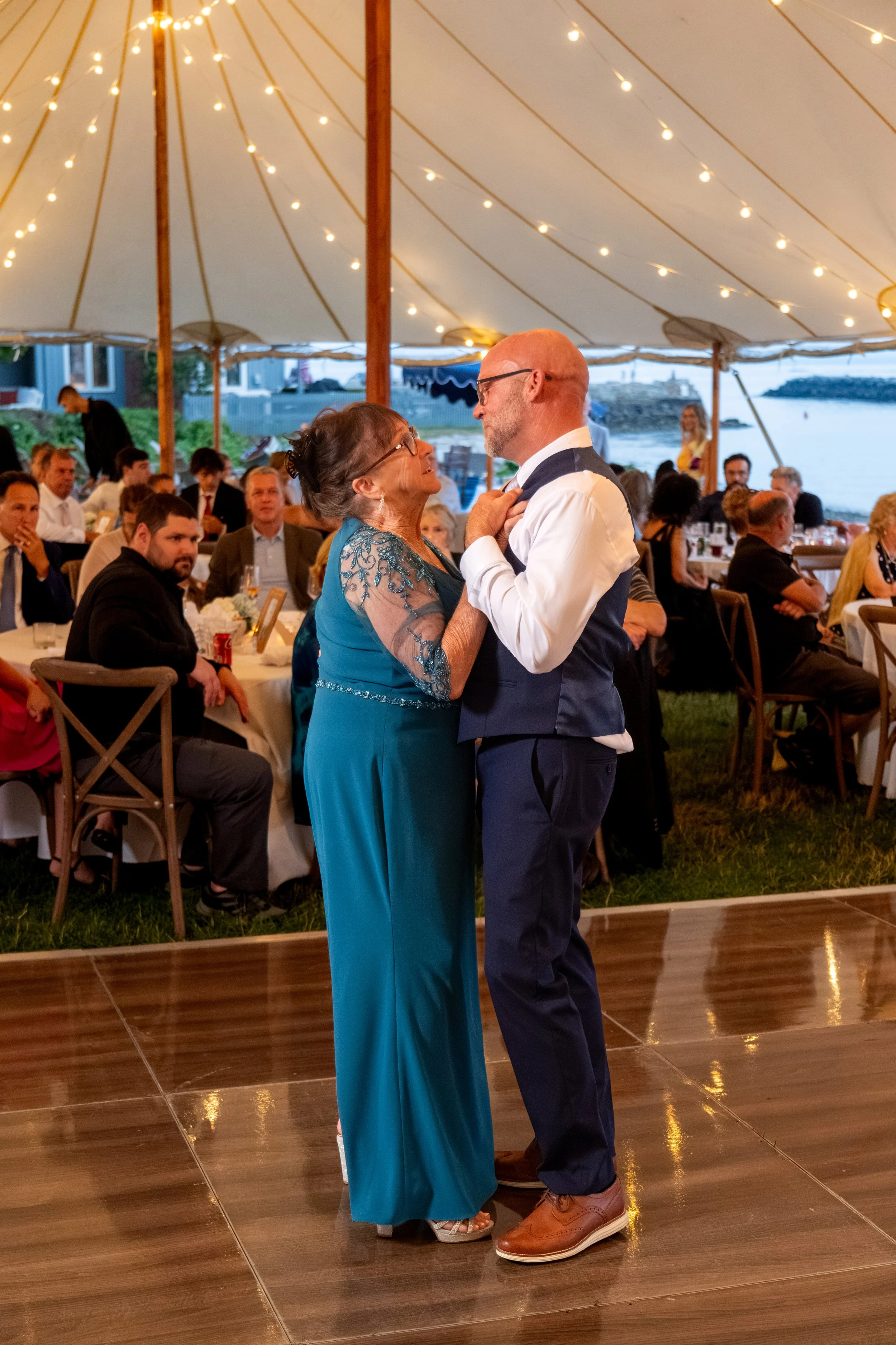 Marc Draper dancing with his mother Marie under the sailcloth tent at The Breakwater Inn in Kennebunkport Maine summer wedding photography VMG Productions