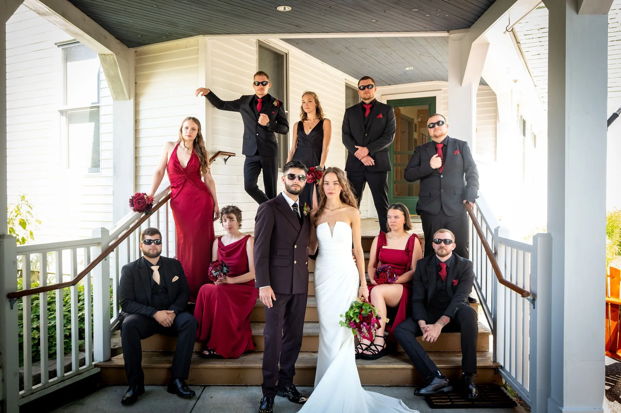 Cassidy and Chase Begin with their full wedding party on the porch steps at Maple Hill Farm Inn and Conference Center in Hallowell Maine summer wedding photography VMG Productions