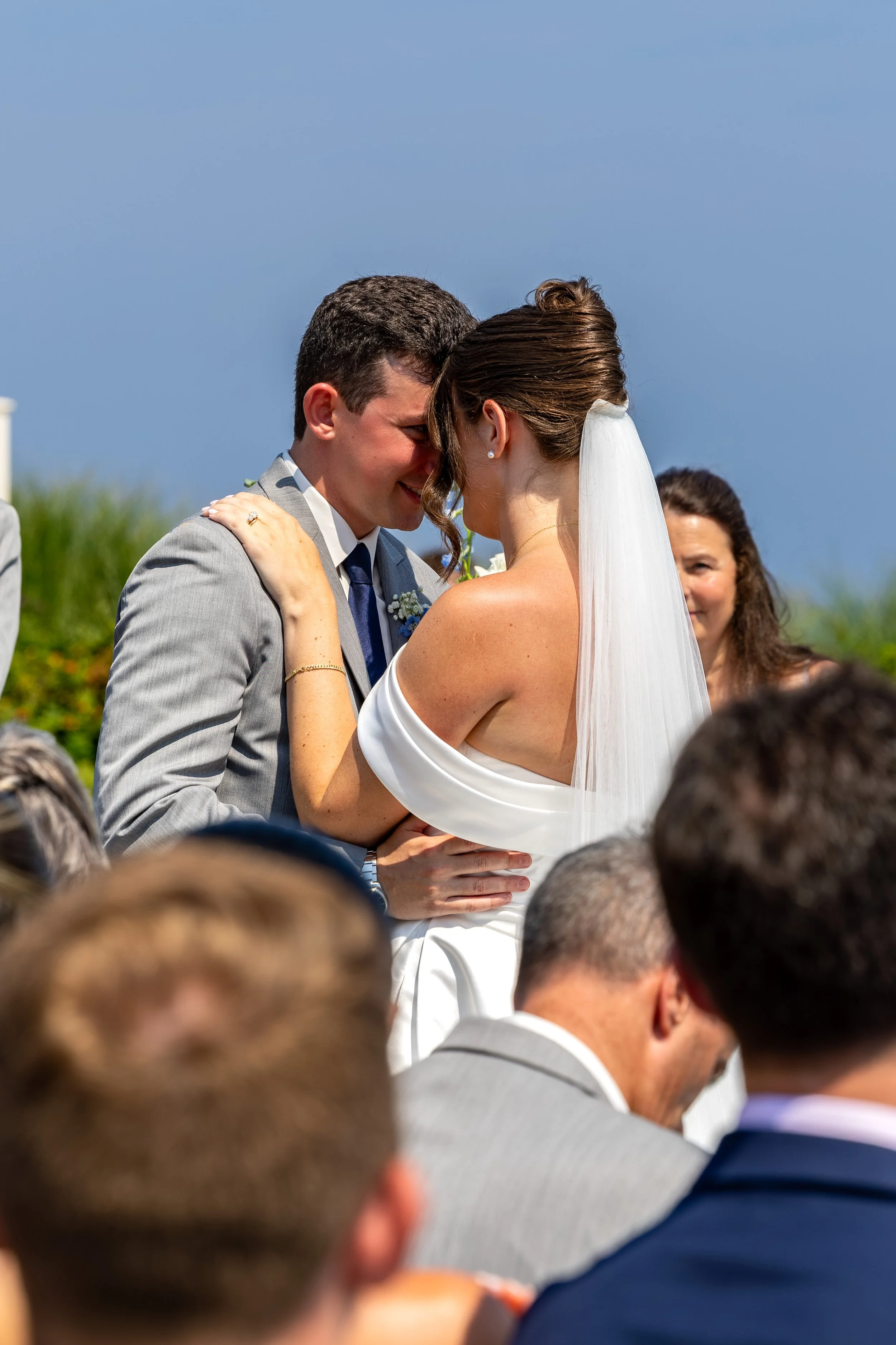 Caroline and Anthony Pirolli with foreheads together in their first embrace after the ceremony at Union Bluff Hotel in York Maine wedding photography VMG Productions