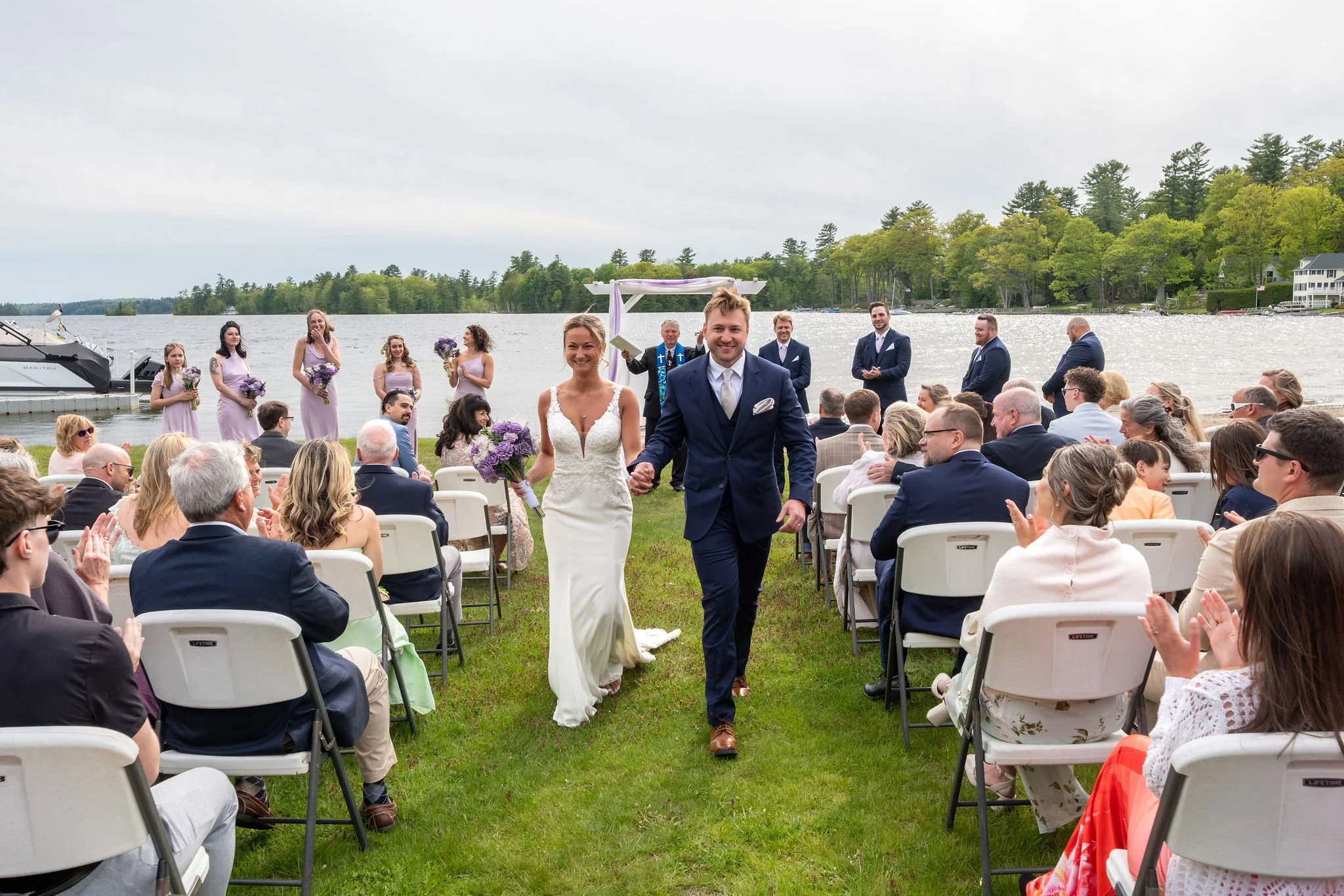 Beth and Cameron bride and groom kissing during the recessional at Augusta Country Club Manchester Maine spring wedding photography VMG Productions