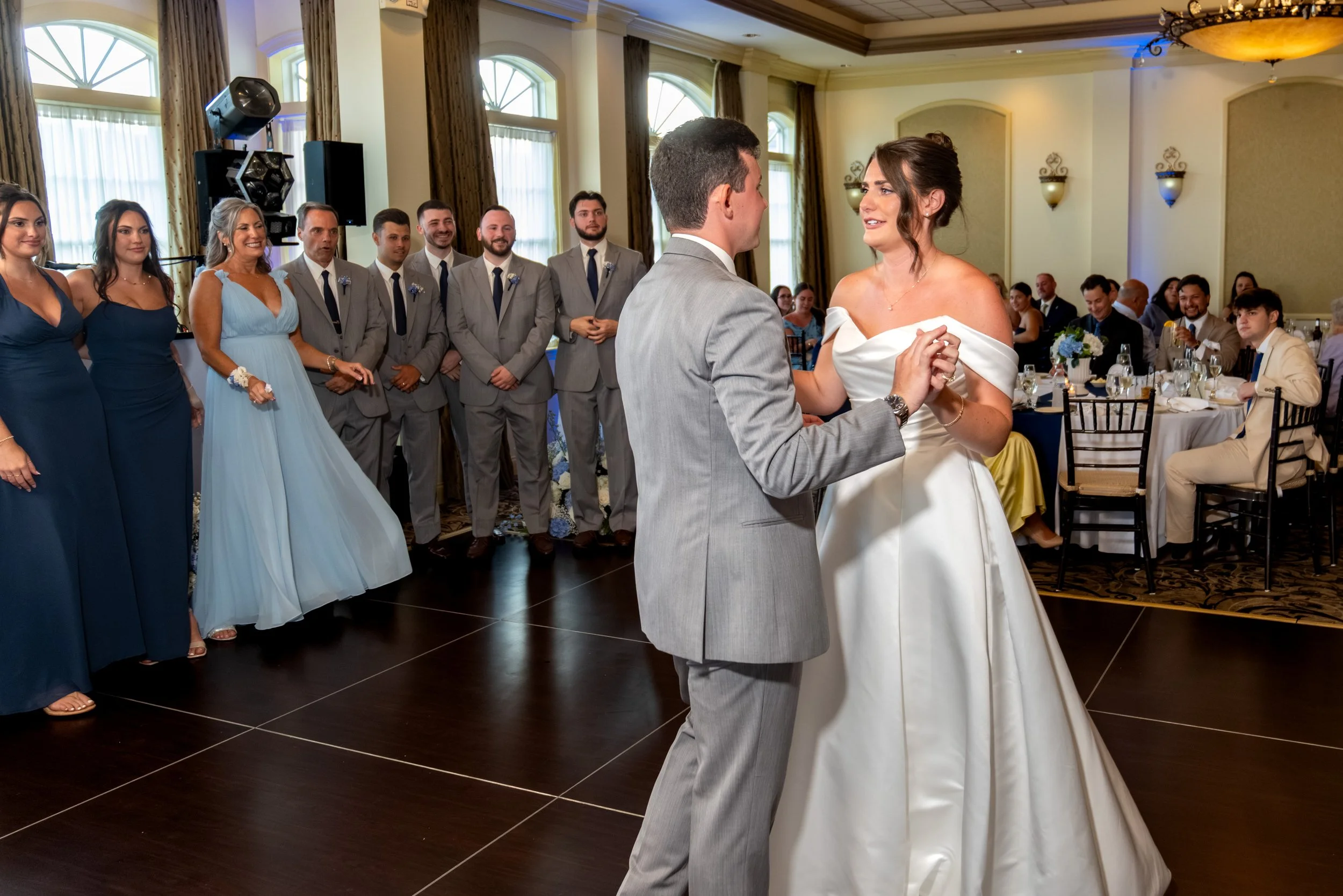 One of Caroline Pirolli's maids of honor in navy giving her speech beside the sweetheart table florals at Union Bluff Hotel in York Maine wedding photography VMG Productions