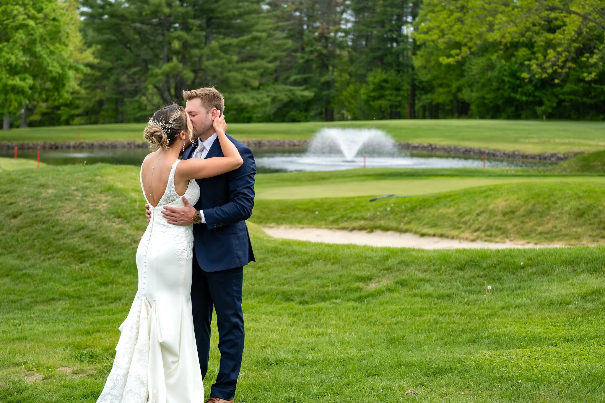 Beth and Cameron bride and groom sharing a kiss at their first look at Augusta Country Club Manchester Maine spring wedding photography VMG Productions