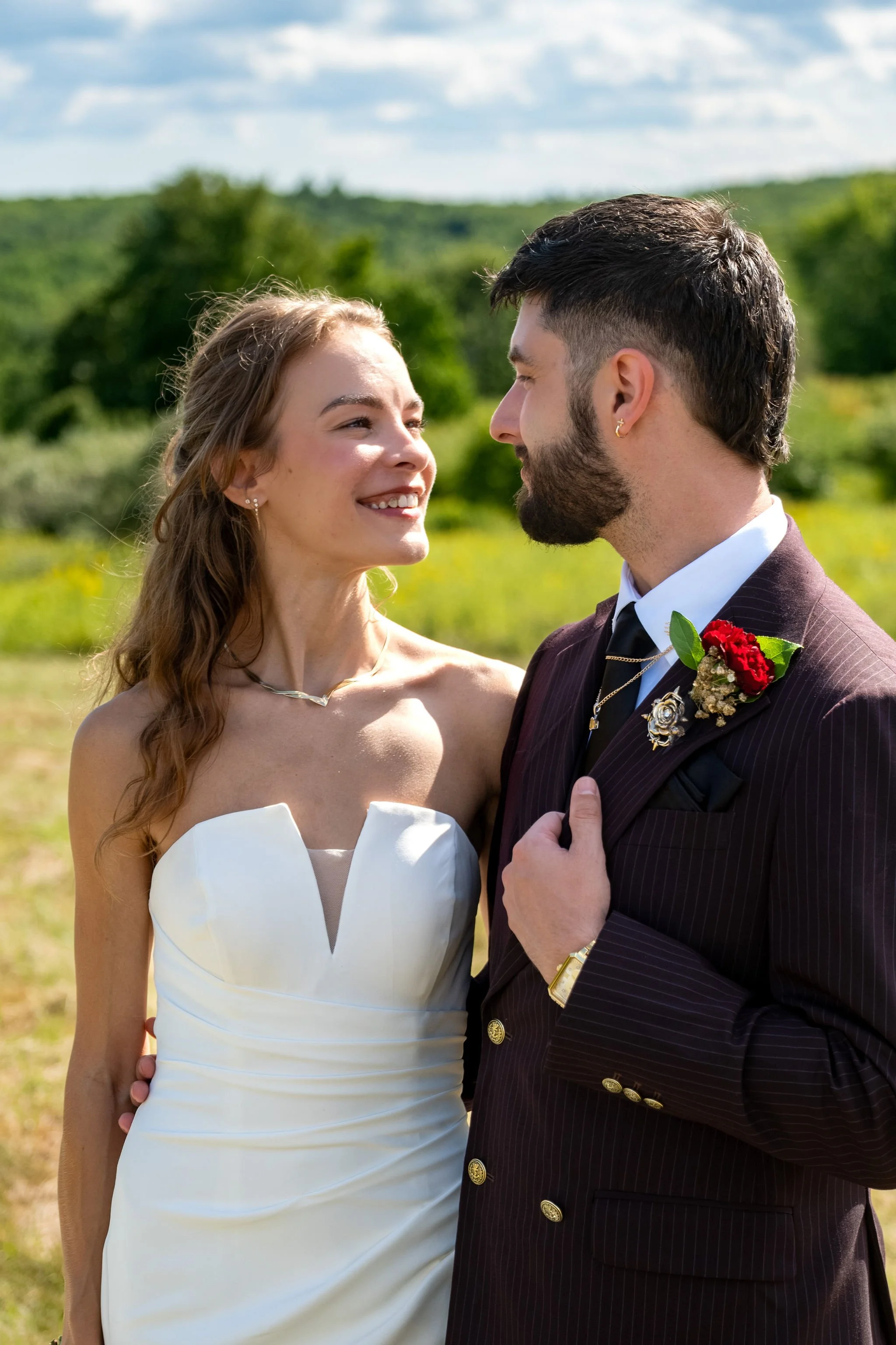 Cassidy and Chase Begin close together in a goldenrod field at Maple Hill Farm Inn and Conference Center in Hallowell Maine summer wedding photography VMG Productions
