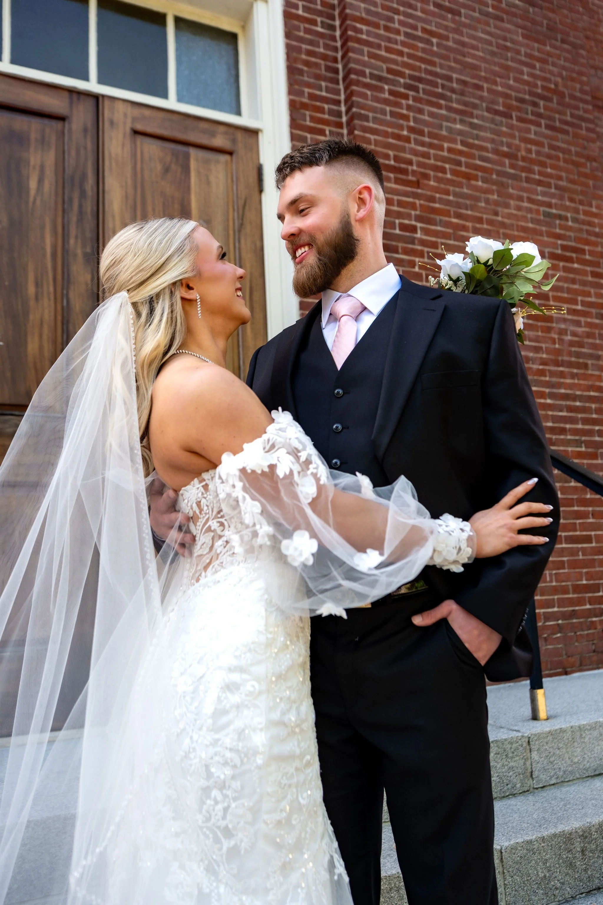 Jeremiah and Vienna close-up portrait emphasizing expressions and bouquet detail at Holy Trinity Greek Orthodox Church Portland Maine spring wedding photography VMG Productions