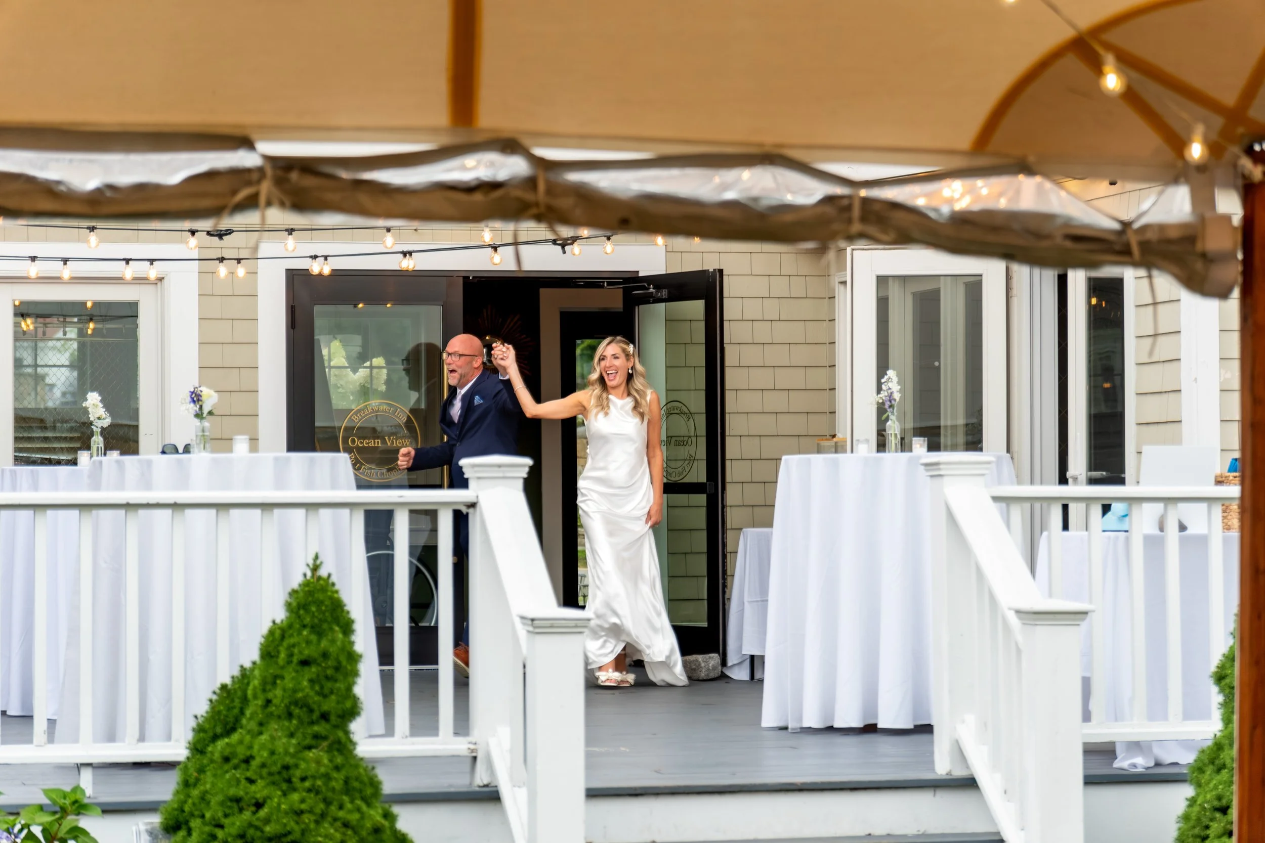Ashley and Marc Draper making their grand entrance to the reception with a live saxophonist at The Breakwater Inn in Kennebunkport Maine summer wedding photography VMG Productions