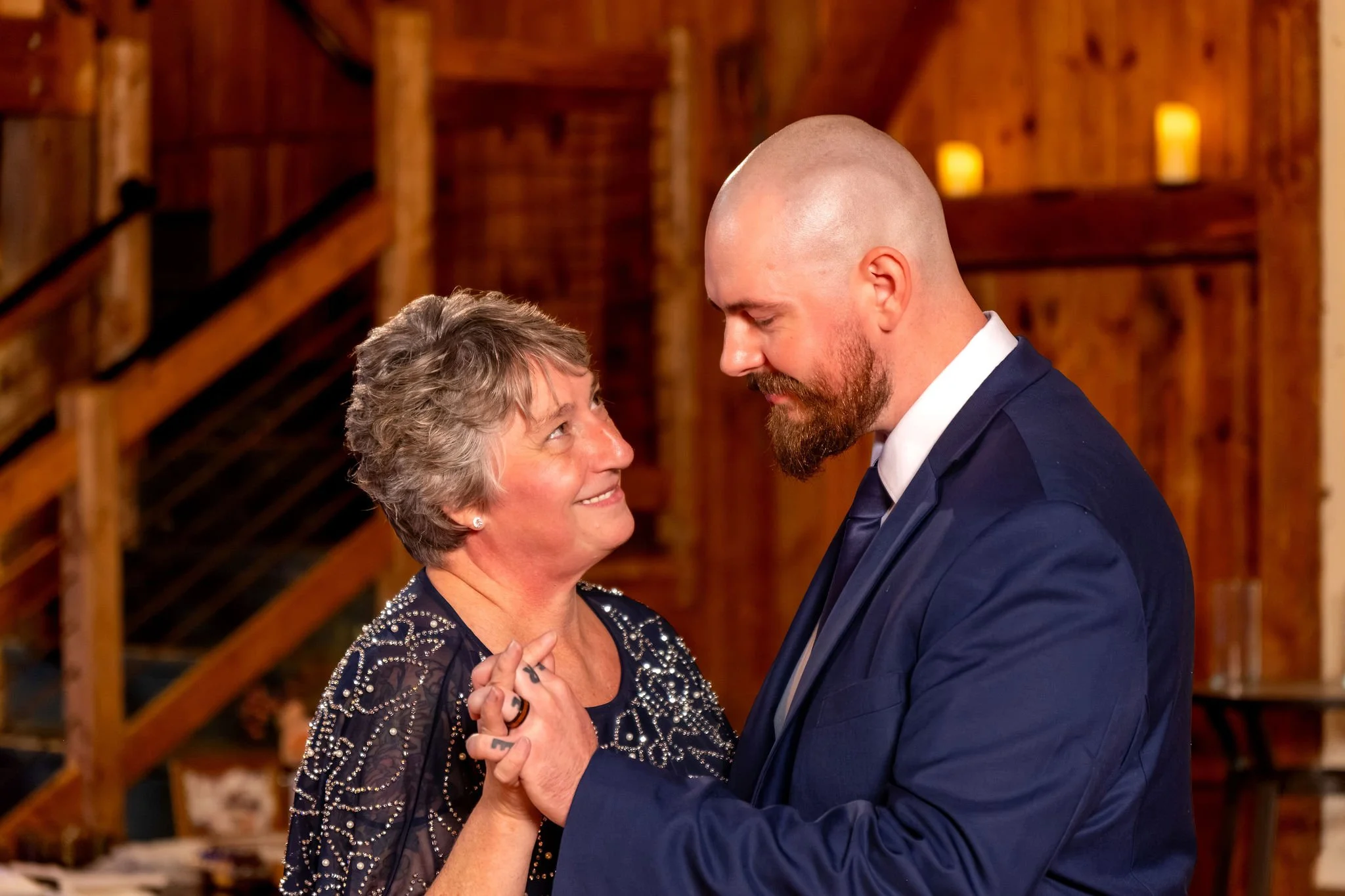 Sam dancing with his mom as she looks up at him with a big smile at Boothbay Playhouse in Boothbay Maine fall wedding photography VMG Productions