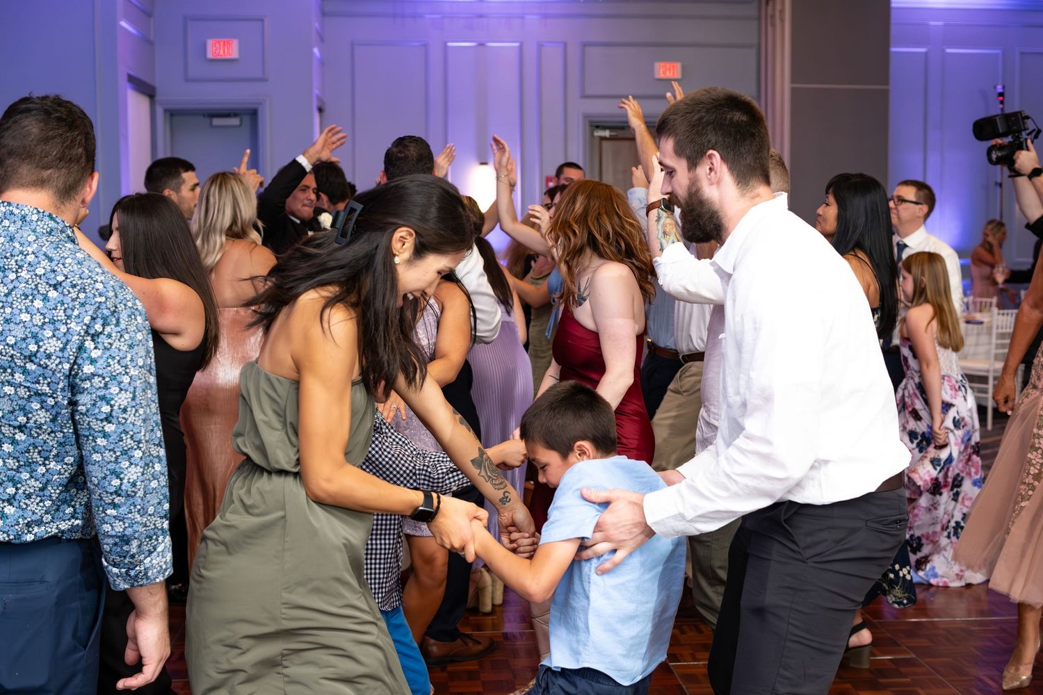 A young guest riding on shoulders above the dance floor at Portland Sheraton at Sable Oaks South Portland Maine summer wedding photography VMG Productions