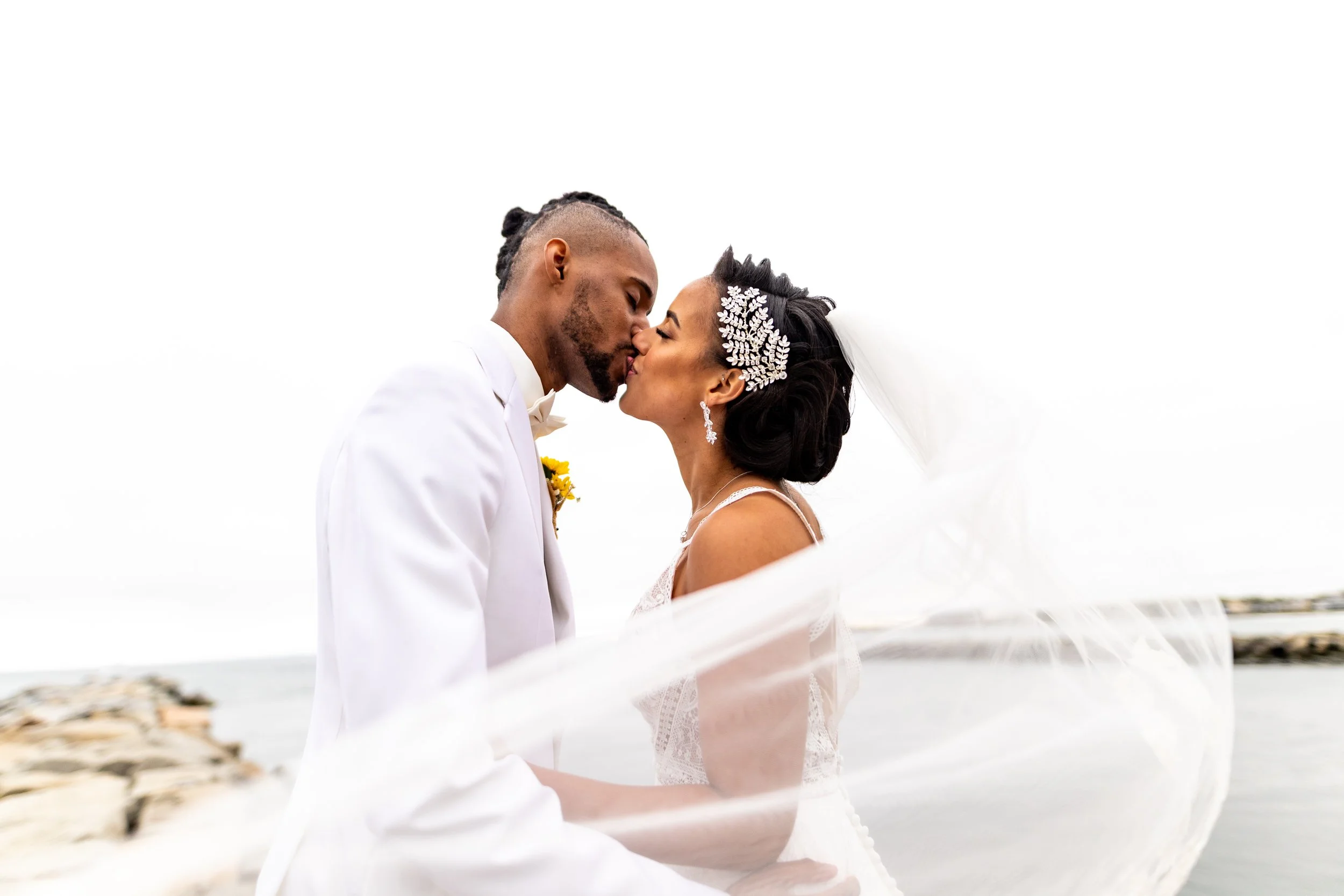 Couple at the coast, veil in motion