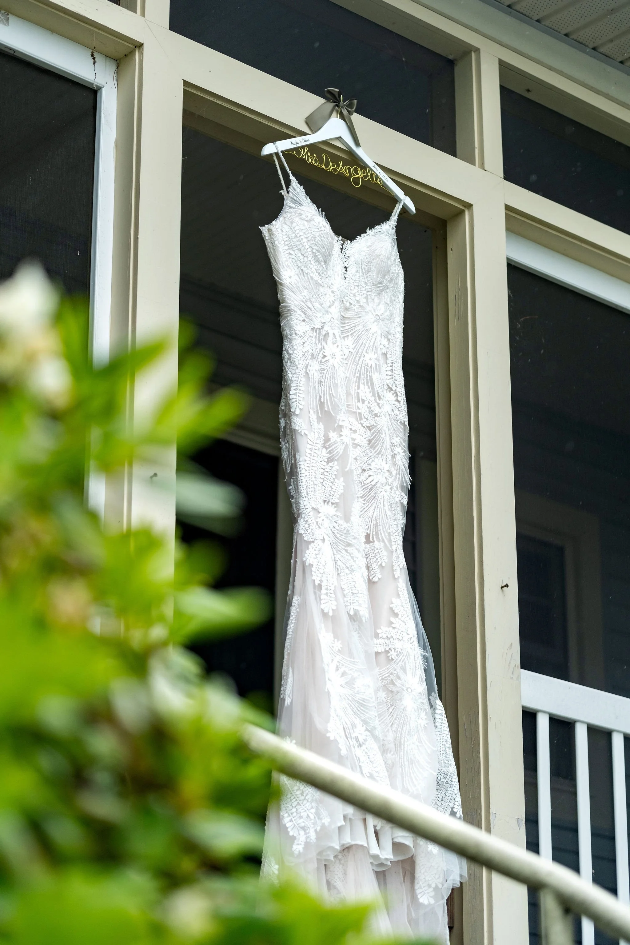 Kayla DeAngelis Mrs. DeAngelis custom wire hanger with the wedding dress hanging at Lake Winnisquam Belmont New Hampshire summer wedding photography VMG Productions