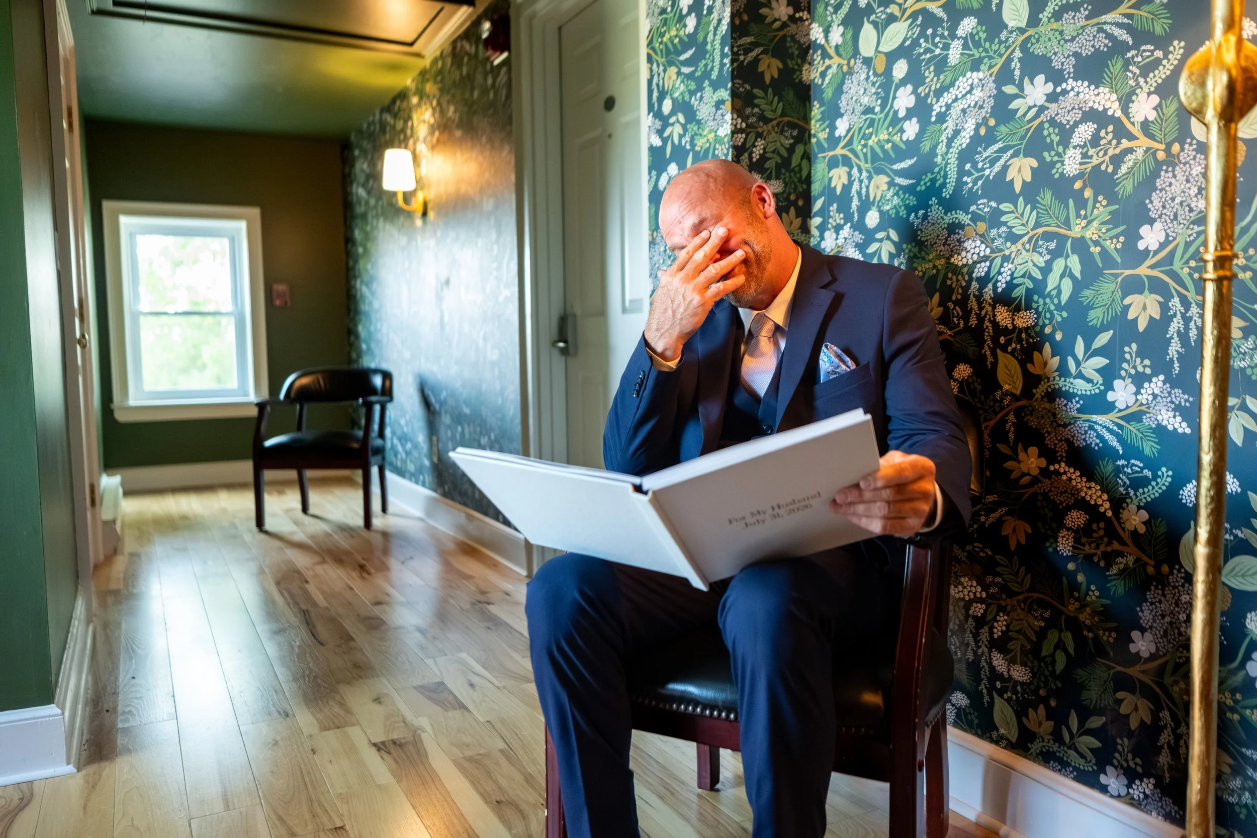 Marc Draper wiping away tears while reading a For My Husband gift book from Ashley before the ceremony at The Breakwater Inn in Kennebunkport Maine summer wedding photography VMG Productions