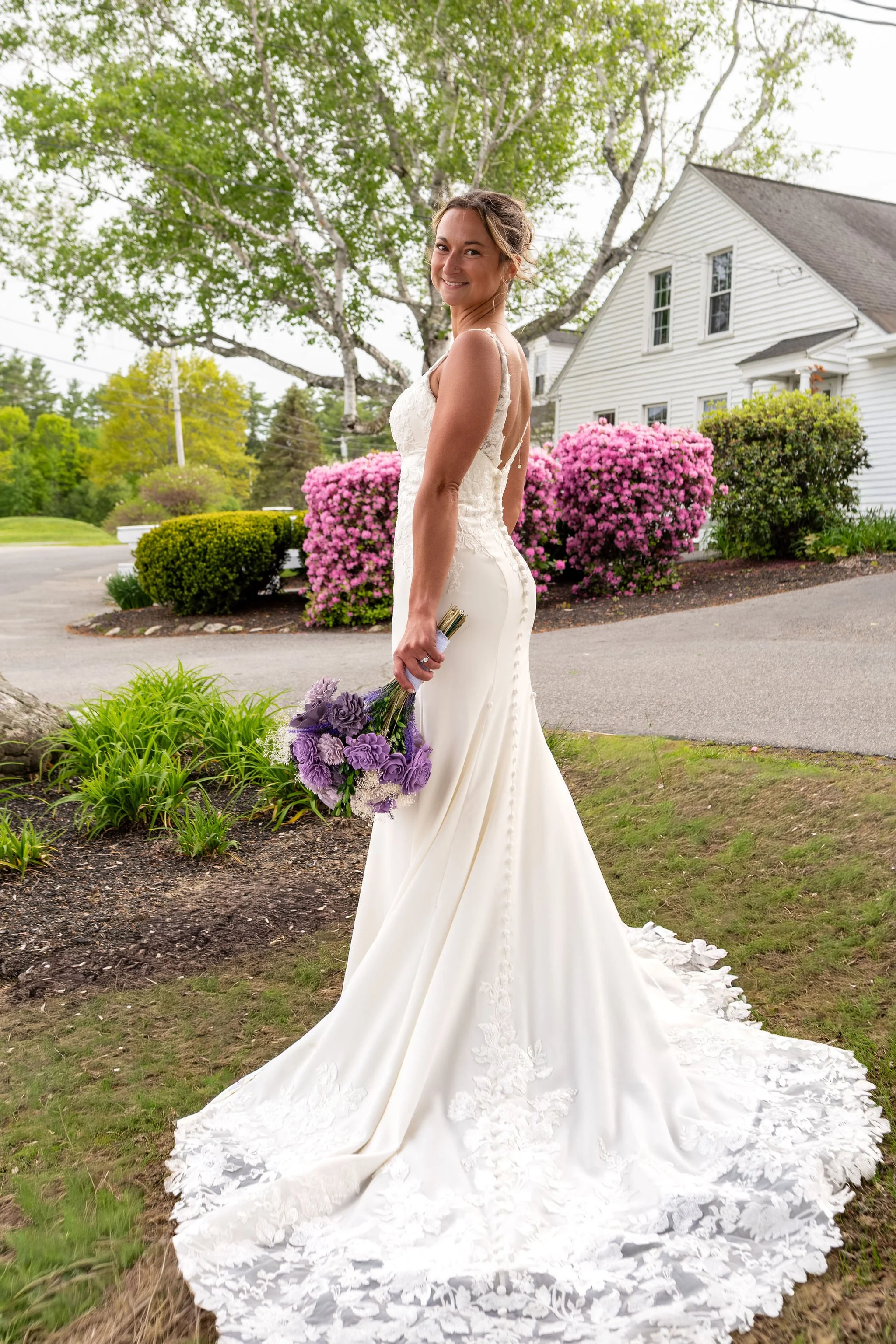 Beth and Cameron bride showing the lace train of her gown at Augusta Country Club Manchester Maine spring wedding photography VMG Productions