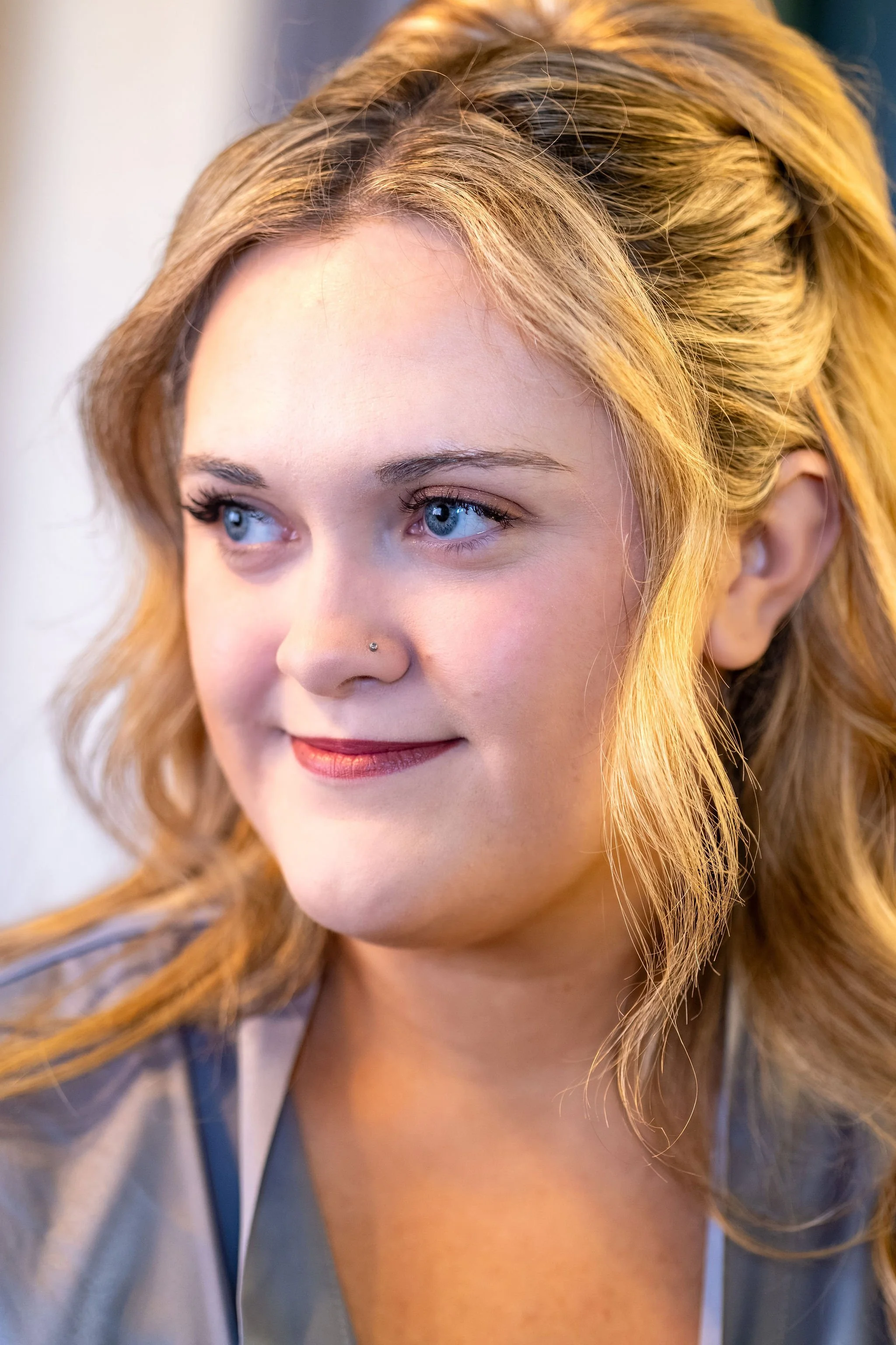 Close portrait of Ellie in her robe looking off to the side with a soft smile at Boothbay Playhouse in Boothbay Maine fall wedding photography VMG Productions