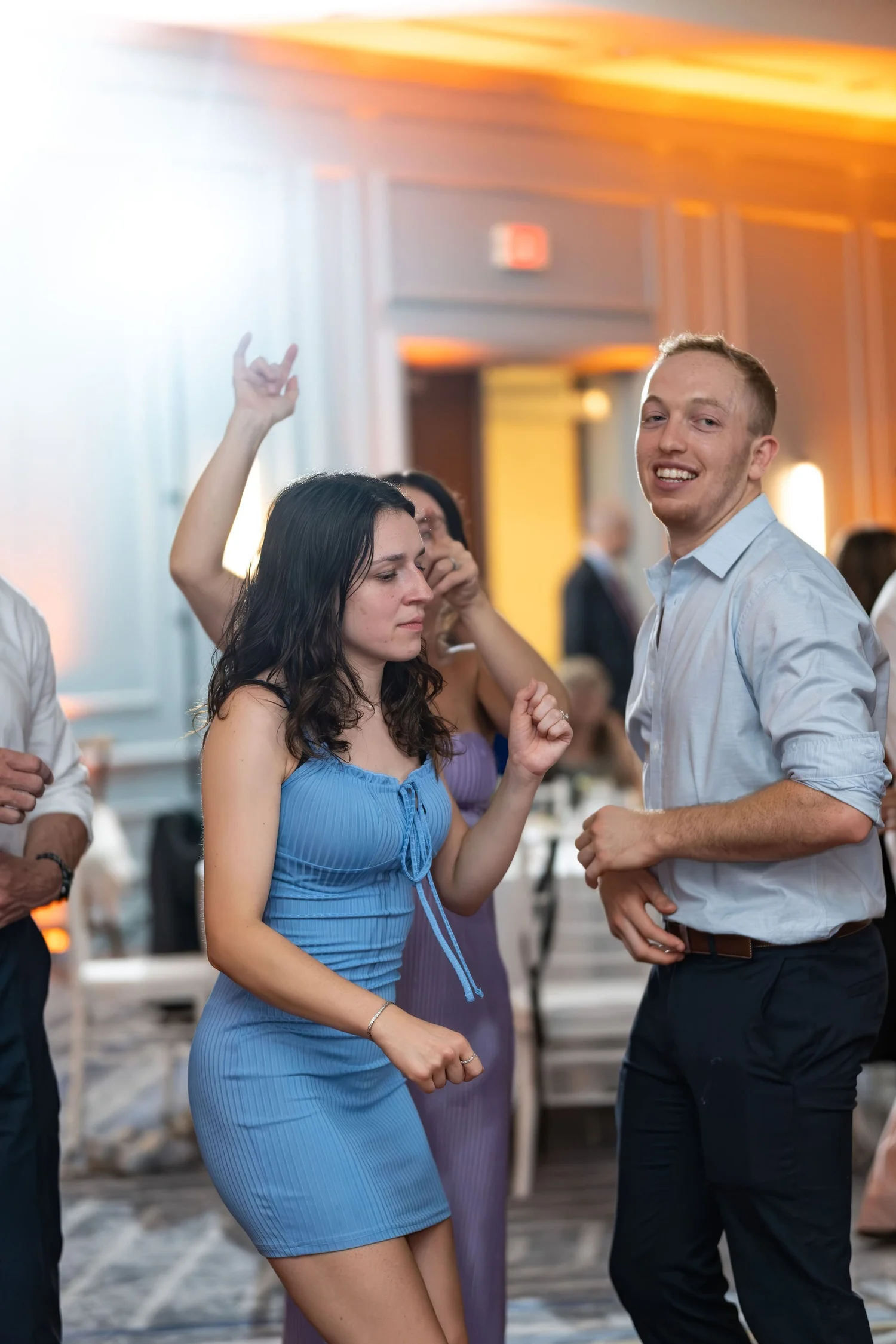A guest dancing with sunglasses tucked under his chin at Portland Sheraton at Sable Oaks South Portland Maine summer wedding photography VMG Productions