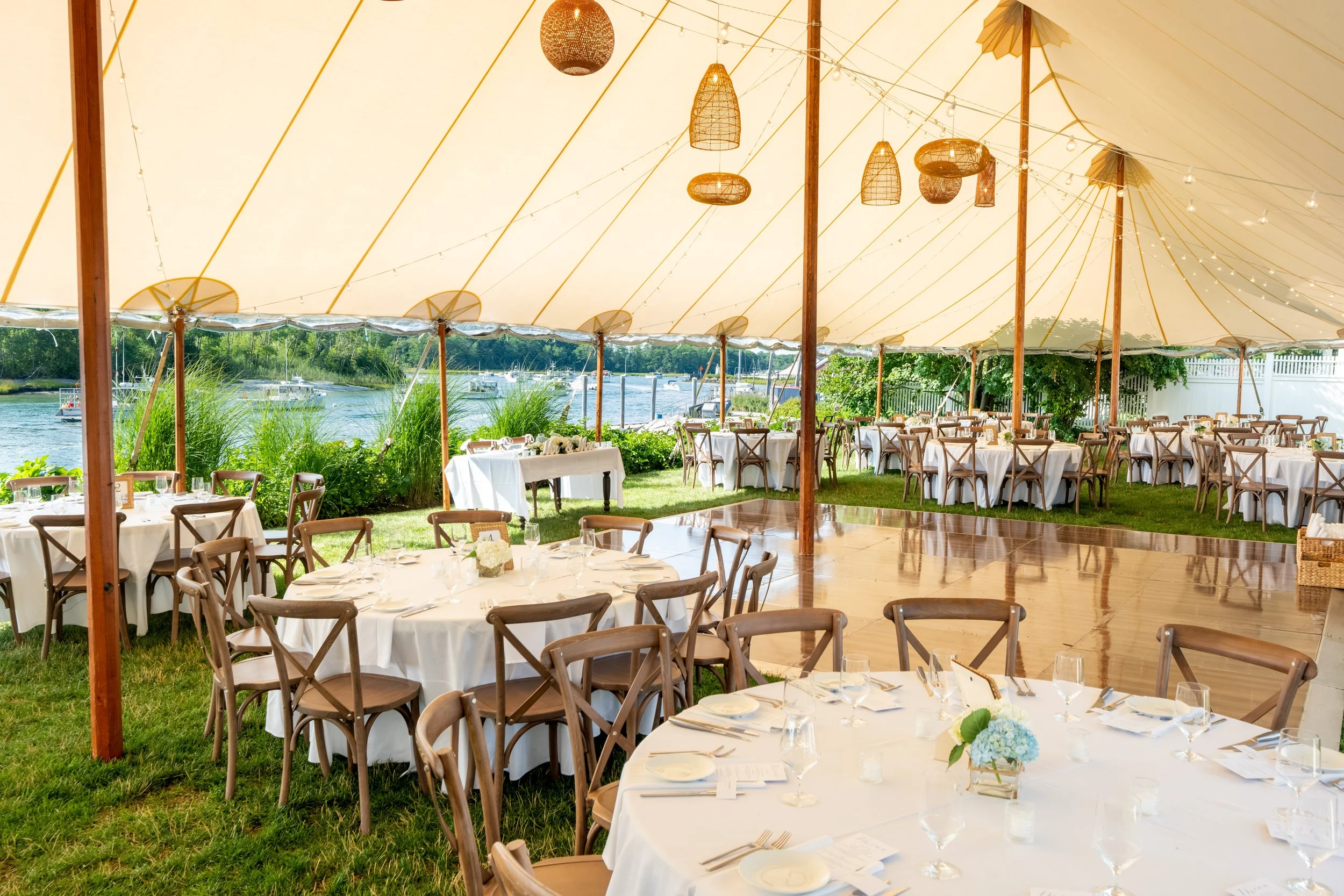 Canvas reception tent set for dinner overlooking the river and ocean at Ashley and Marc Draper's wedding at The Breakwater Inn in Kennebunkport Maine summer wedding photography VMG Productions