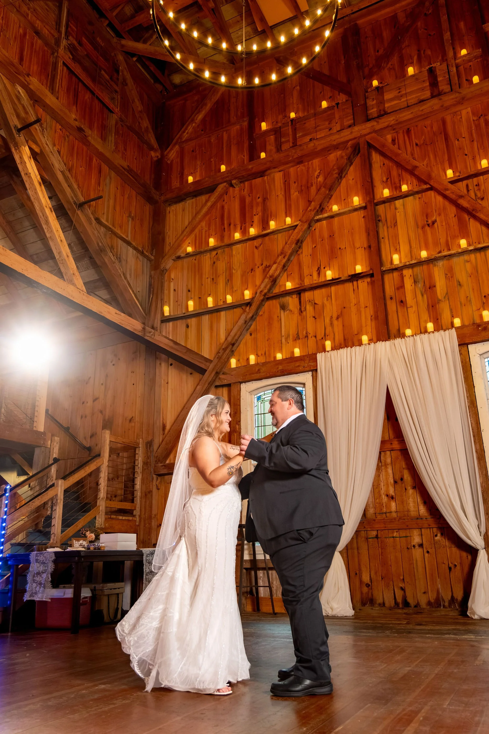 Ellie dancing with her dad on the barn floor under the candlelit walls at Boothbay Playhouse in Boothbay Maine fall wedding photography VMG Productions