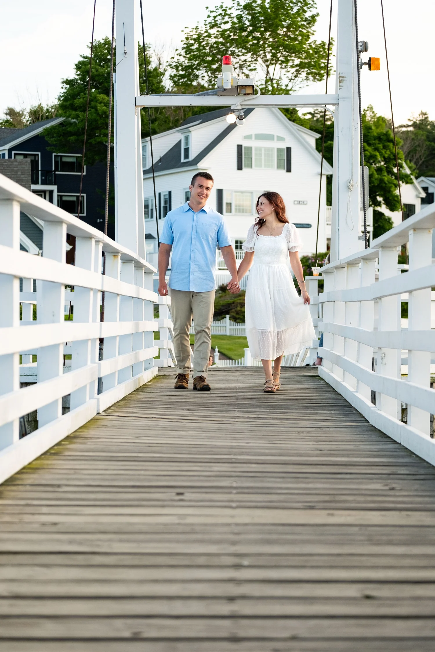 Couple walking the Perkins Cove drawbridge, Ogunquit, Maine, by VMG Productions