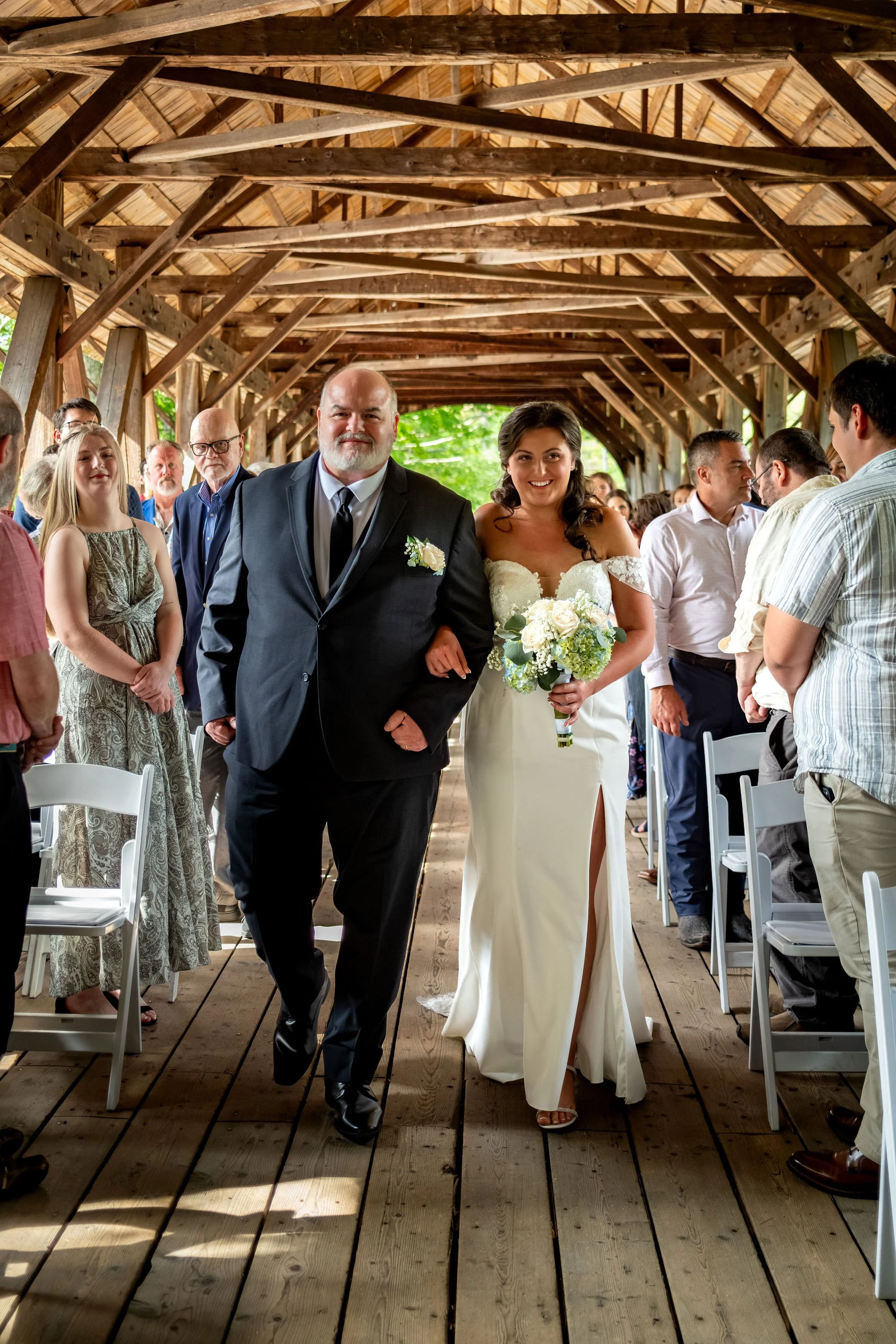 Alyssa and Colby the bride walking down the aisle on her dad's arm at Sunday River Covered Bridge Newry Maine summer wedding photography VMG Productions