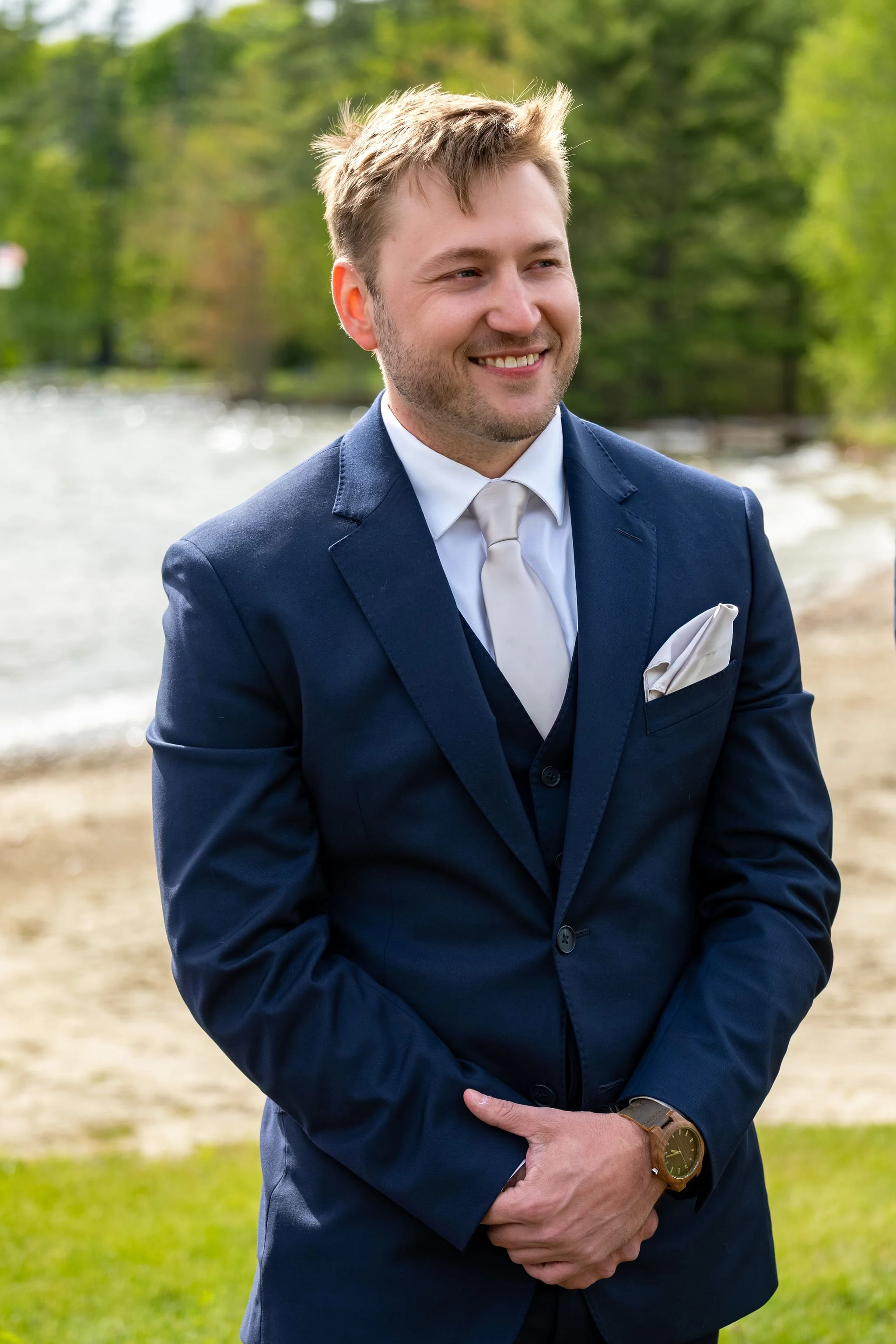 Beth and Cameron groom portrait before the lakeside ceremony at Augusta Country Club Manchester Maine spring wedding photography VMG Productions