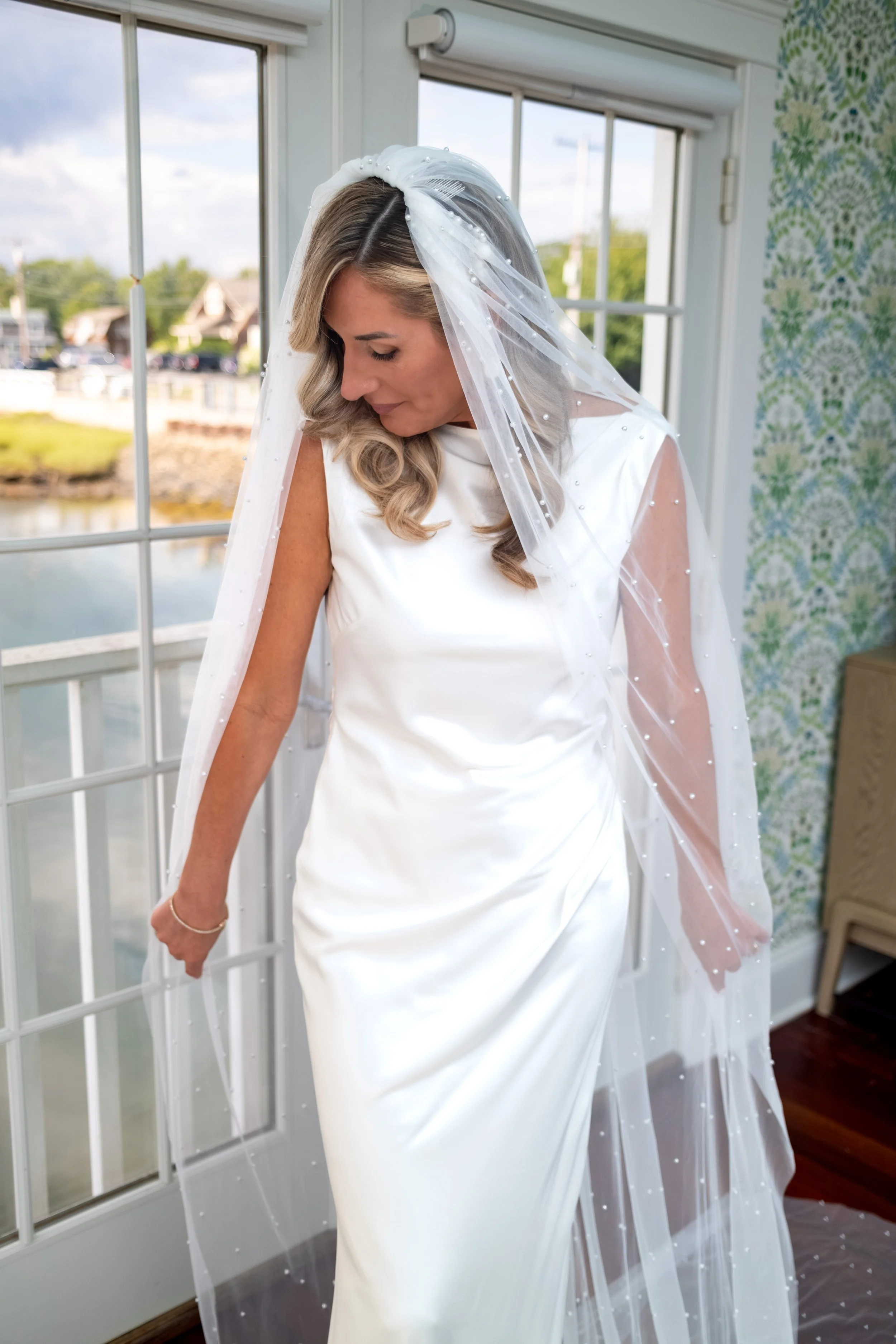 Ashley Draper in her gown and veil ready to walk to the ceremony at The Breakwater Inn in Kennebunkport Maine summer wedding photography VMG Productions