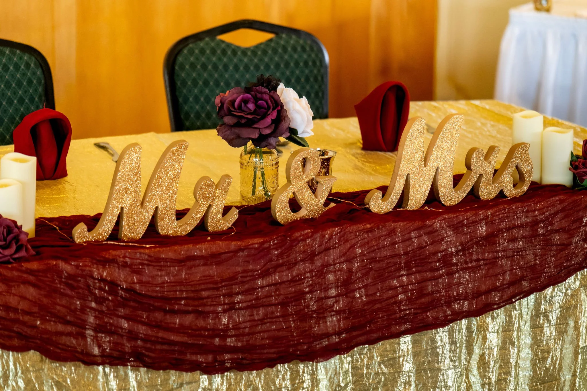 Gold glitter Mr and Mrs sign on the burgundy and gold head table at Cassidy and Chase Begin's reception at Maple Hill Farm Inn and Conference Center in Hallowell Maine summer wedding photography VMG Productions