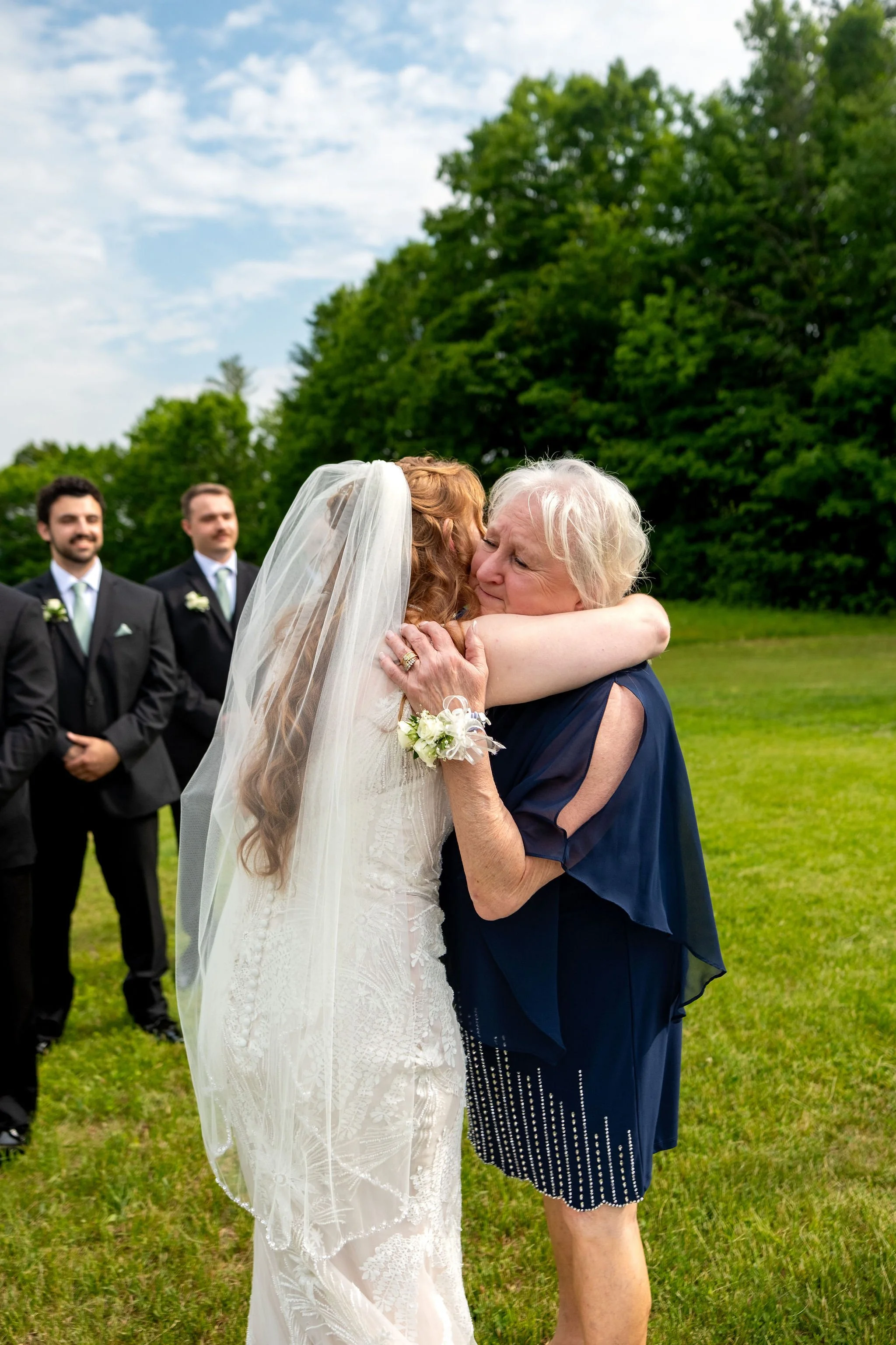 Kayla DeAngelis embracing her mother after the ceremony at their Sanbornton New Hampshire backyard wedding photography VMG Productions