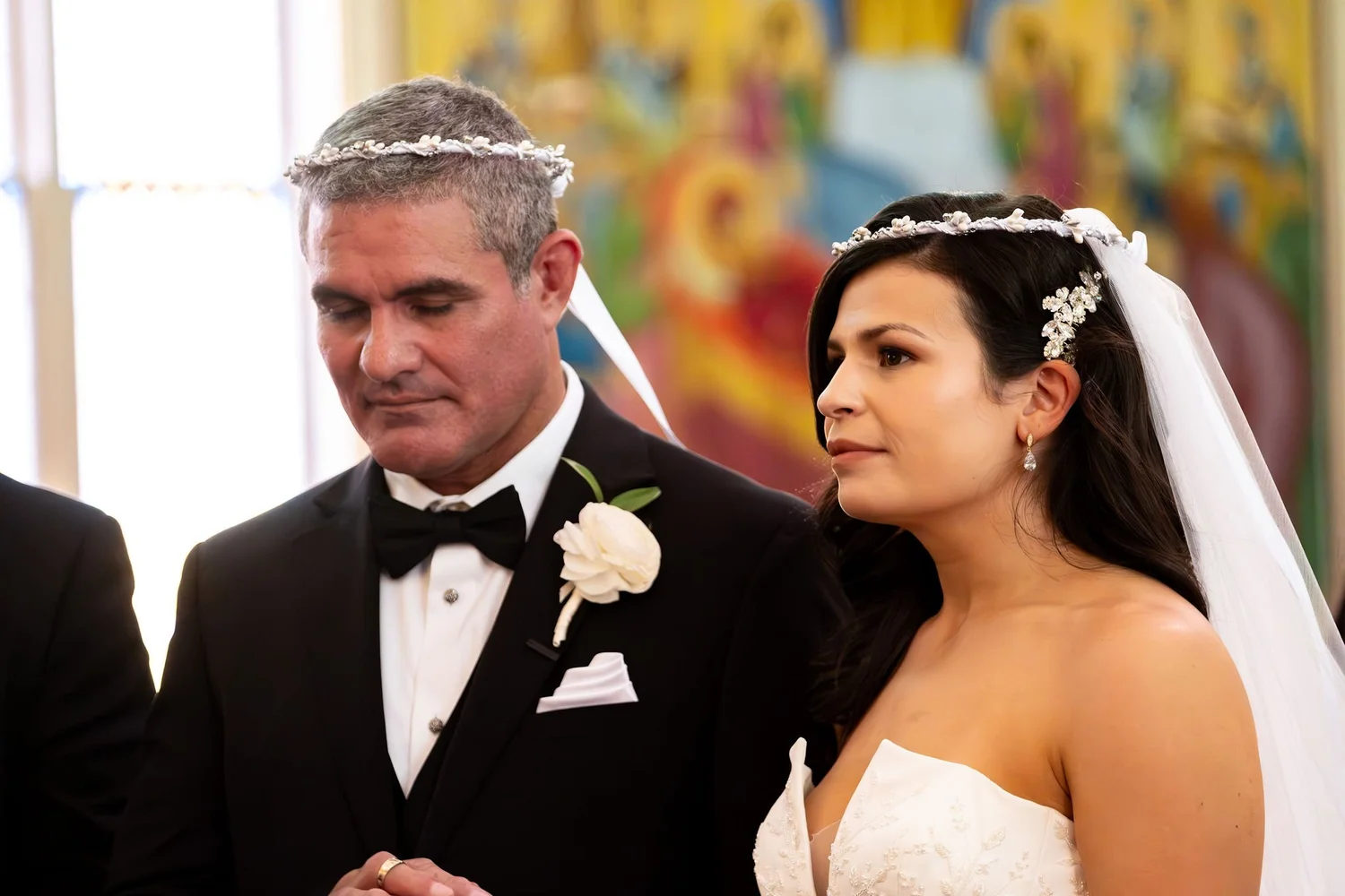 Nicole and Alexey standing crowned before the altar at Holy Trinity Greek Orthodox Church Portland Maine summer wedding photography VMG Productions