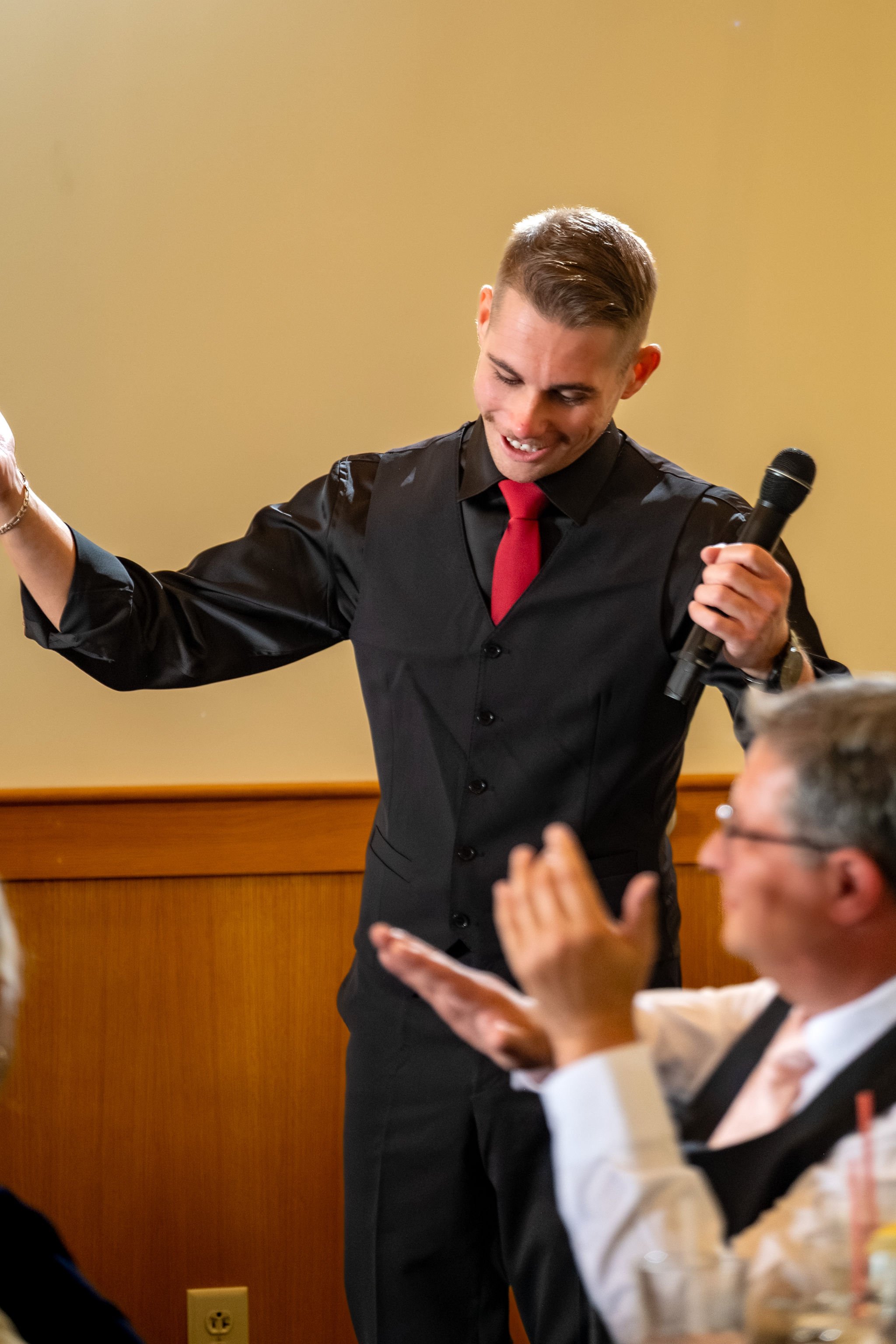 The best man giving his speech at Cassidy and Chase Begin's reception at Maple Hill Farm Inn and Conference Center in Hallowell Maine summer wedding photography VMG Productions