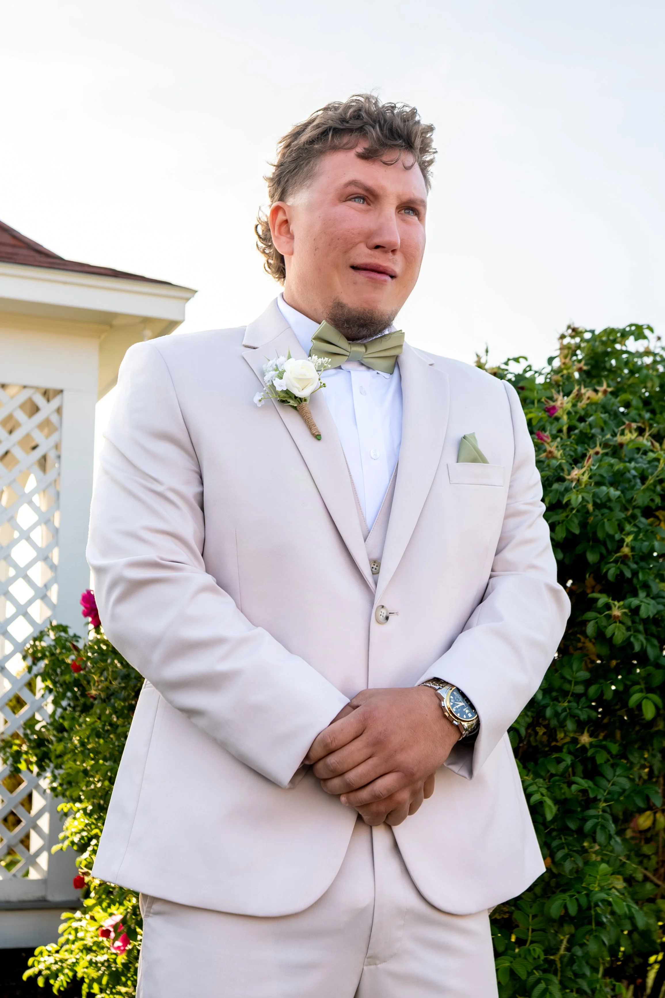 Andrew in his tan suit looking up with a trembling smile as the ceremony begins at the Maine Wedding Barn and Event Center in Minot Maine fall wedding photography VMG Productions