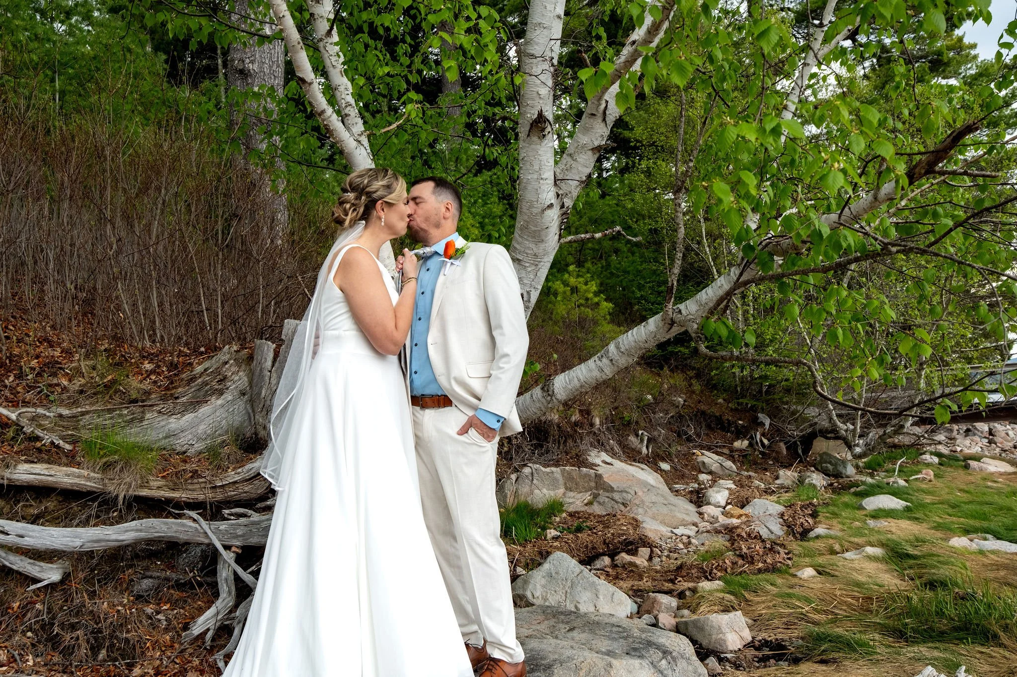 Alli and Adam Baudoin close together by the birch trees above Somes Sound at their Mount Desert Maine spring wedding photography VMG Productions