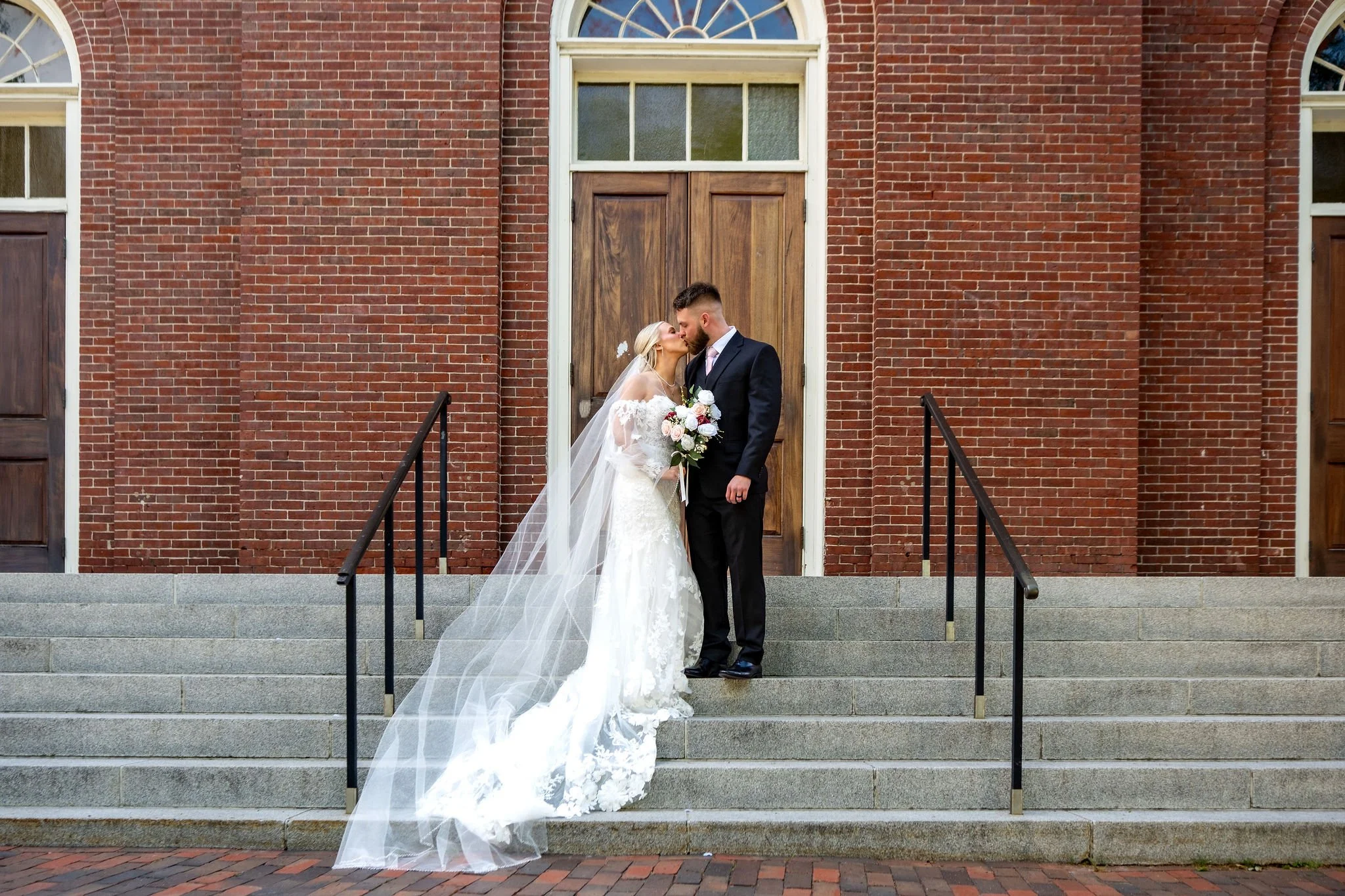 Jeremiah and Vienna horizontal composition featuring staircase symmetry and veil detail at Holy Trinity Greek Orthodox Church Portland Maine spring wedding photography VMG Productions