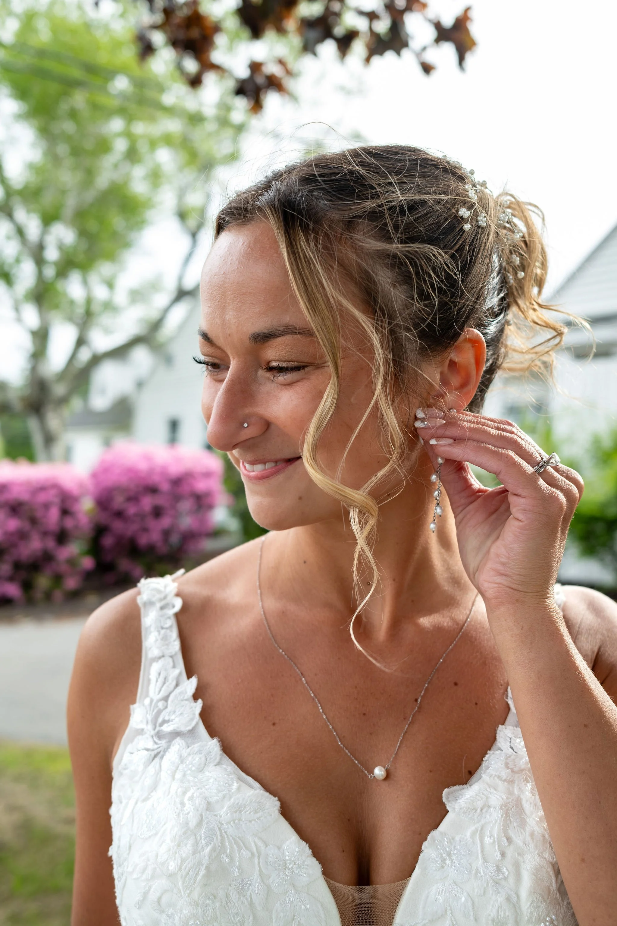 Beth and Cameron bride adjusting her pearl earring during portraits at Augusta Country Club Manchester Maine spring wedding photography VMG Productions