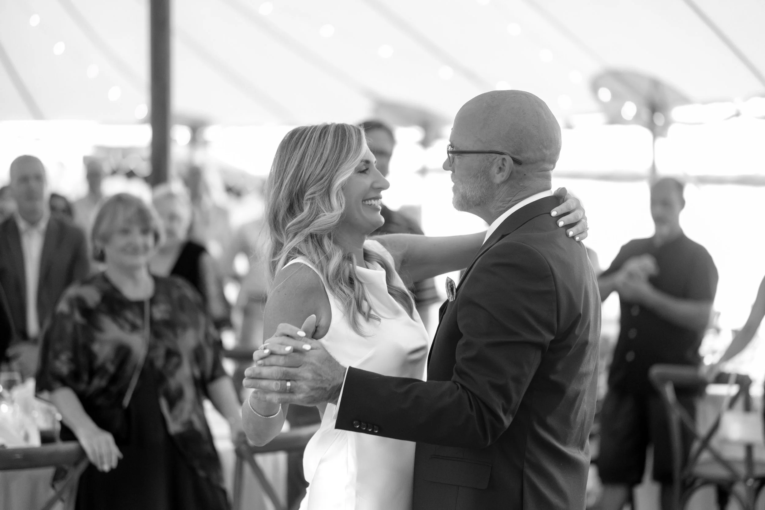 Ashley and Marc Draper dancing under the tent in black and white at The Breakwater Inn in Kennebunkport Maine summer wedding photography VMG Productions