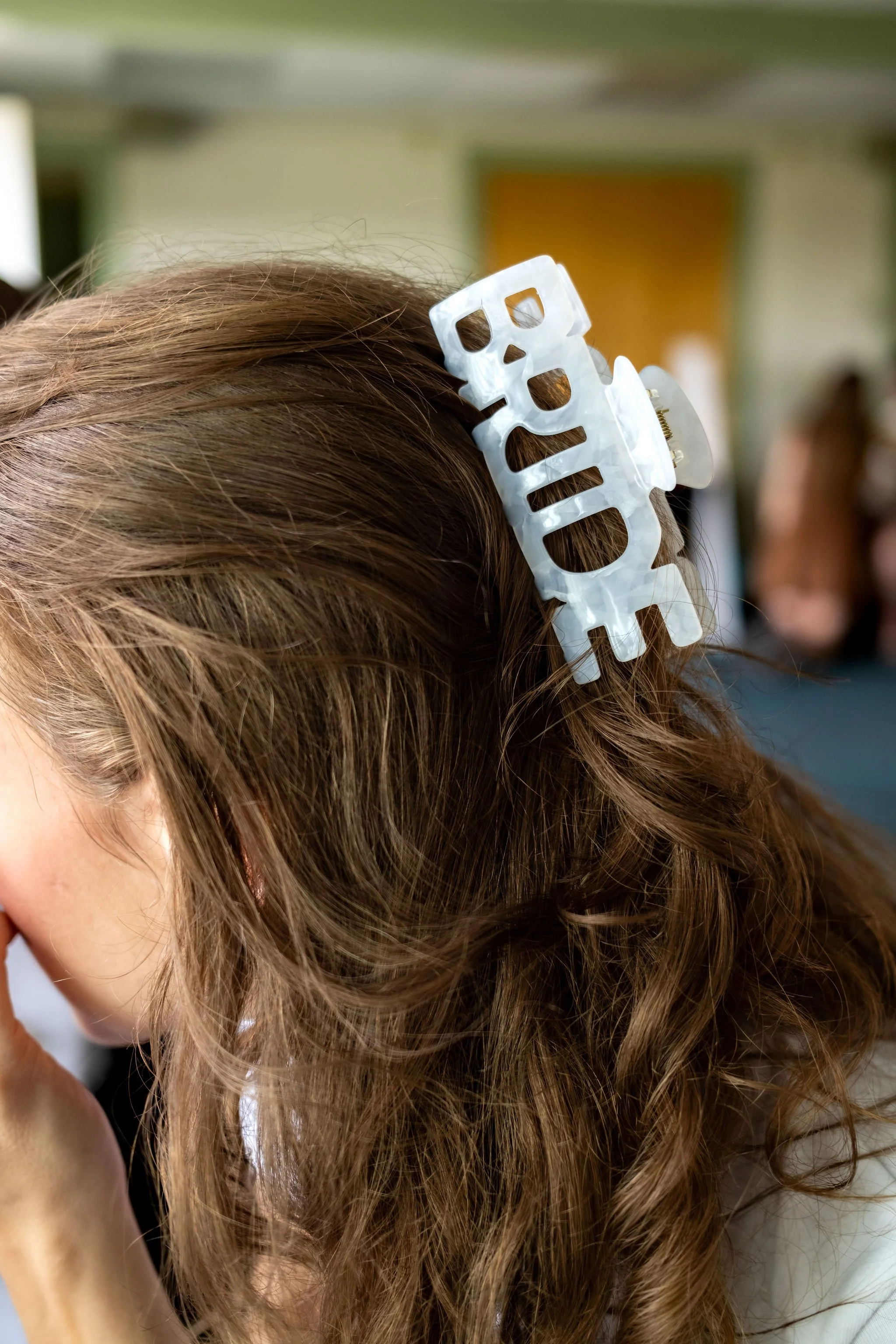 Cassidy Begin's white BRIDE claw clip in her hair while getting ready at Maple Hill Farm Inn and Conference Center in Hallowell Maine summer wedding photography VMG Productions