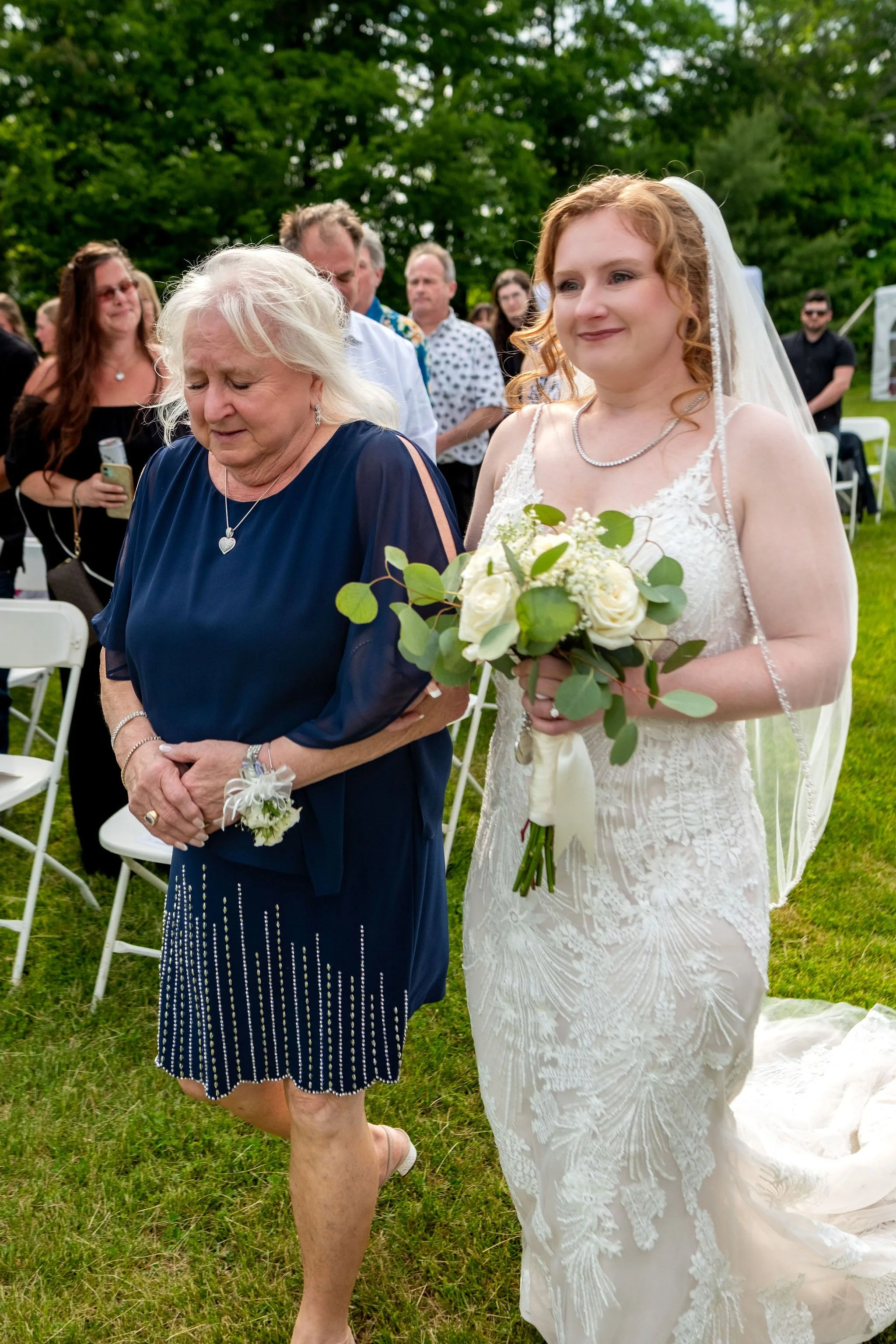 Kayla DeAngelis walking down the aisle with her mother at their Sanbornton New Hampshire backyard wedding photography VMG Productions