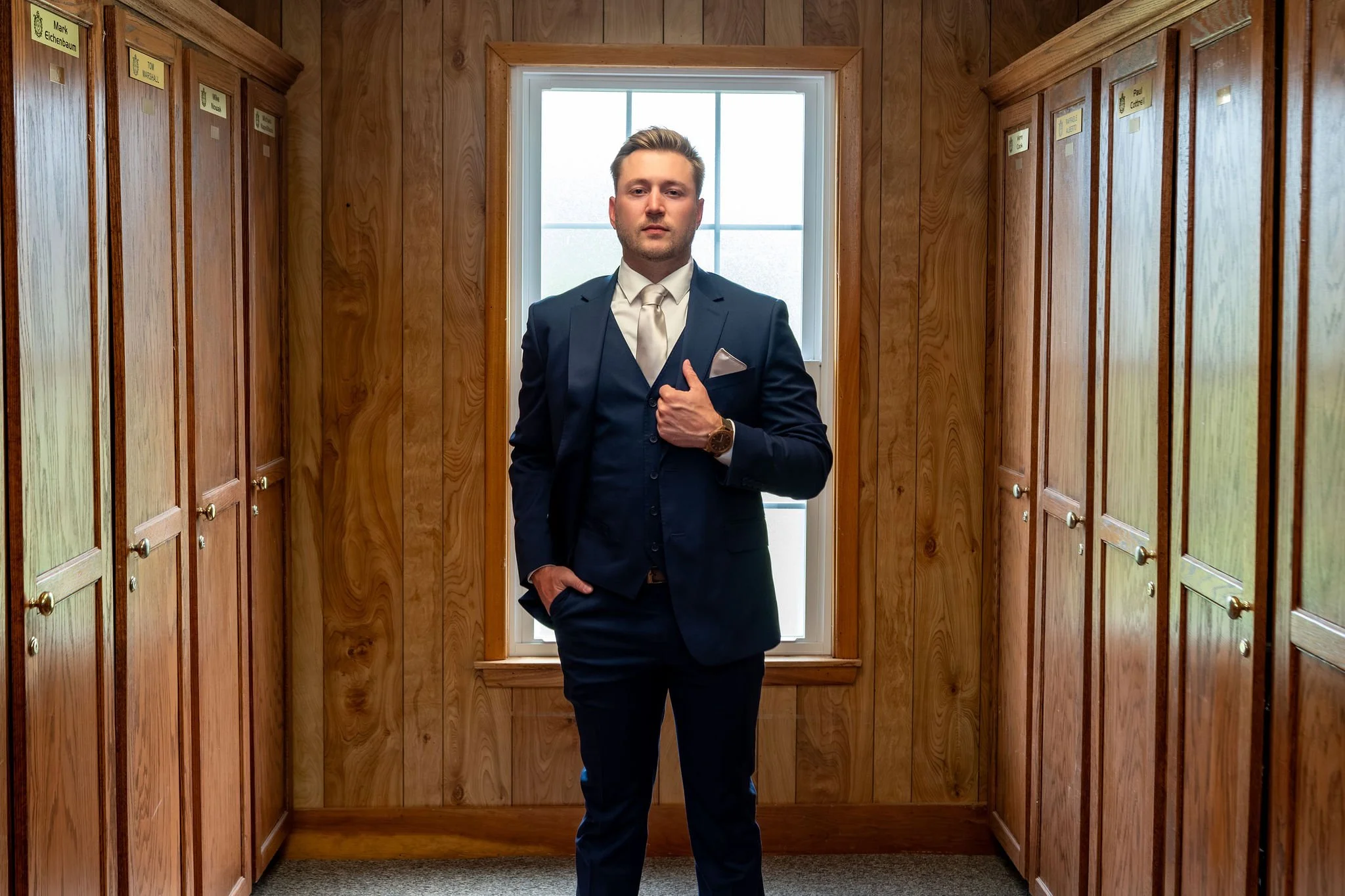 Beth and Cameron groom portrait in the locker room before the ceremony at Augusta Country Club Manchester Maine spring wedding photography VMG Productions