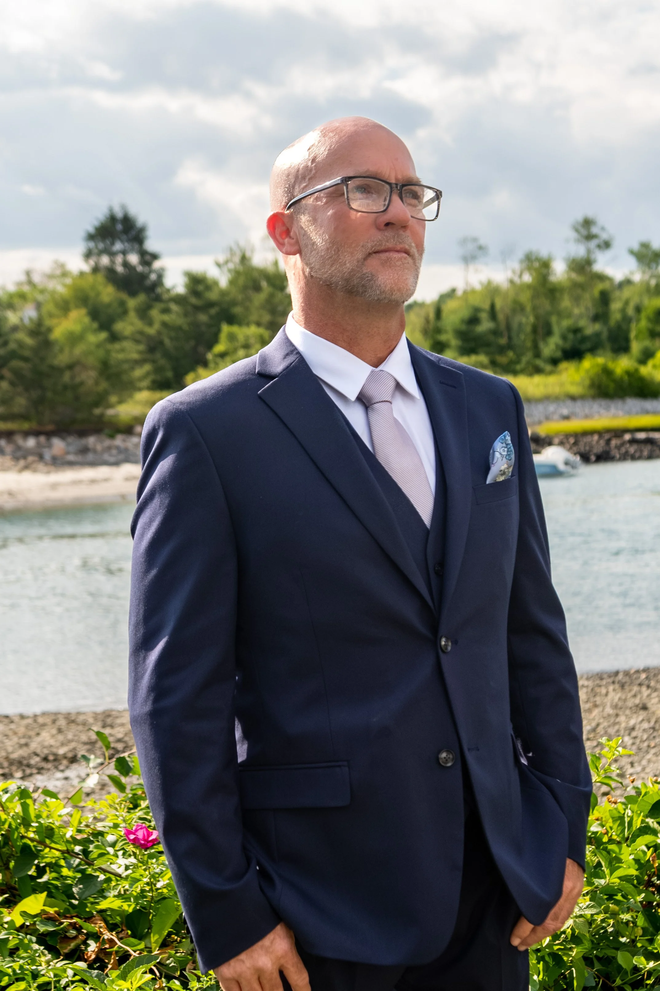Marc Draper waiting at the front of the waterfront ceremony for Ashley at The Breakwater Inn in Kennebunkport Maine summer wedding photography VMG Productions