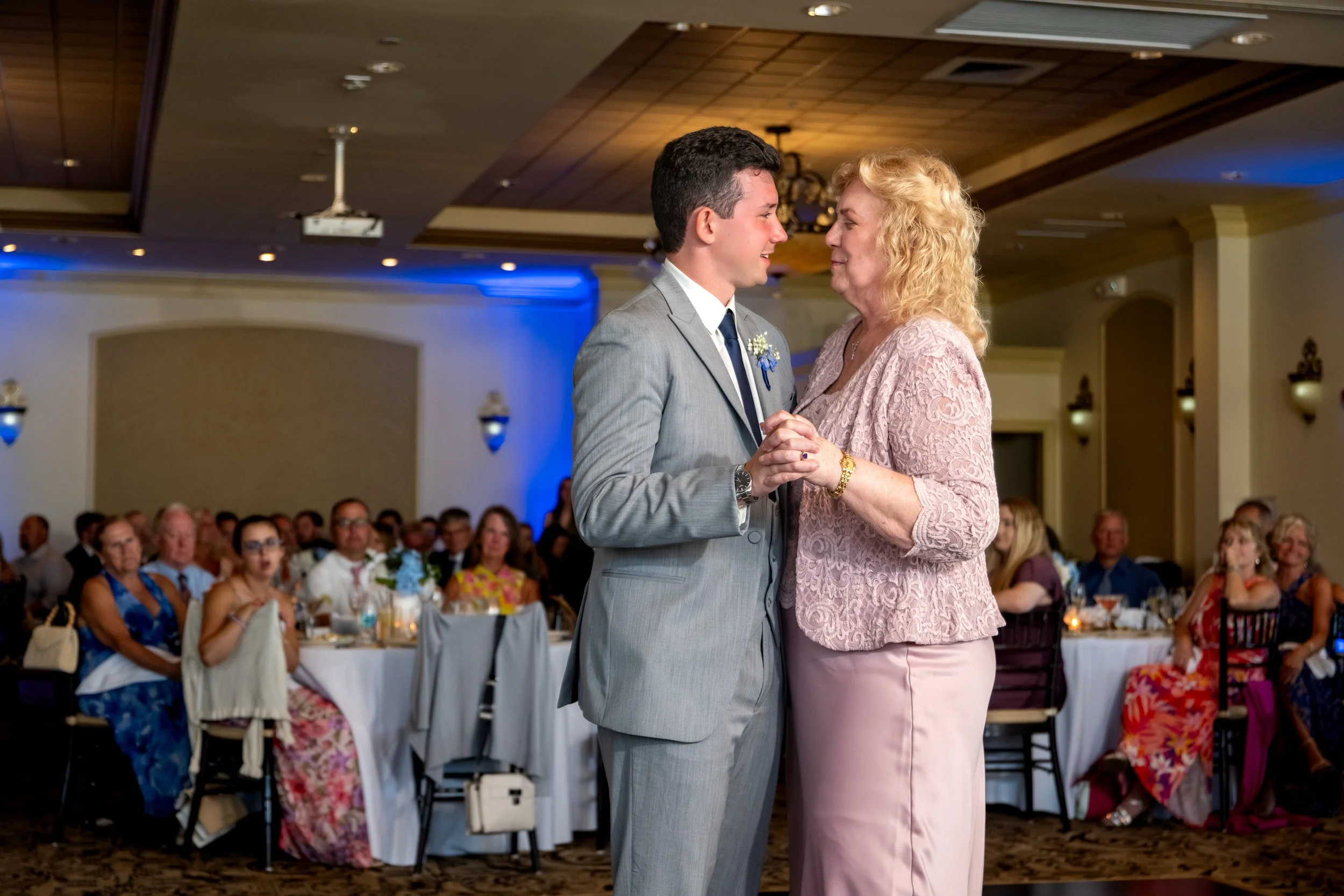 Anthony Pirolli dancing forehead to forehead with his mother during the mother-son dance at Union Bluff Hotel in York Maine wedding photography VMG Productions