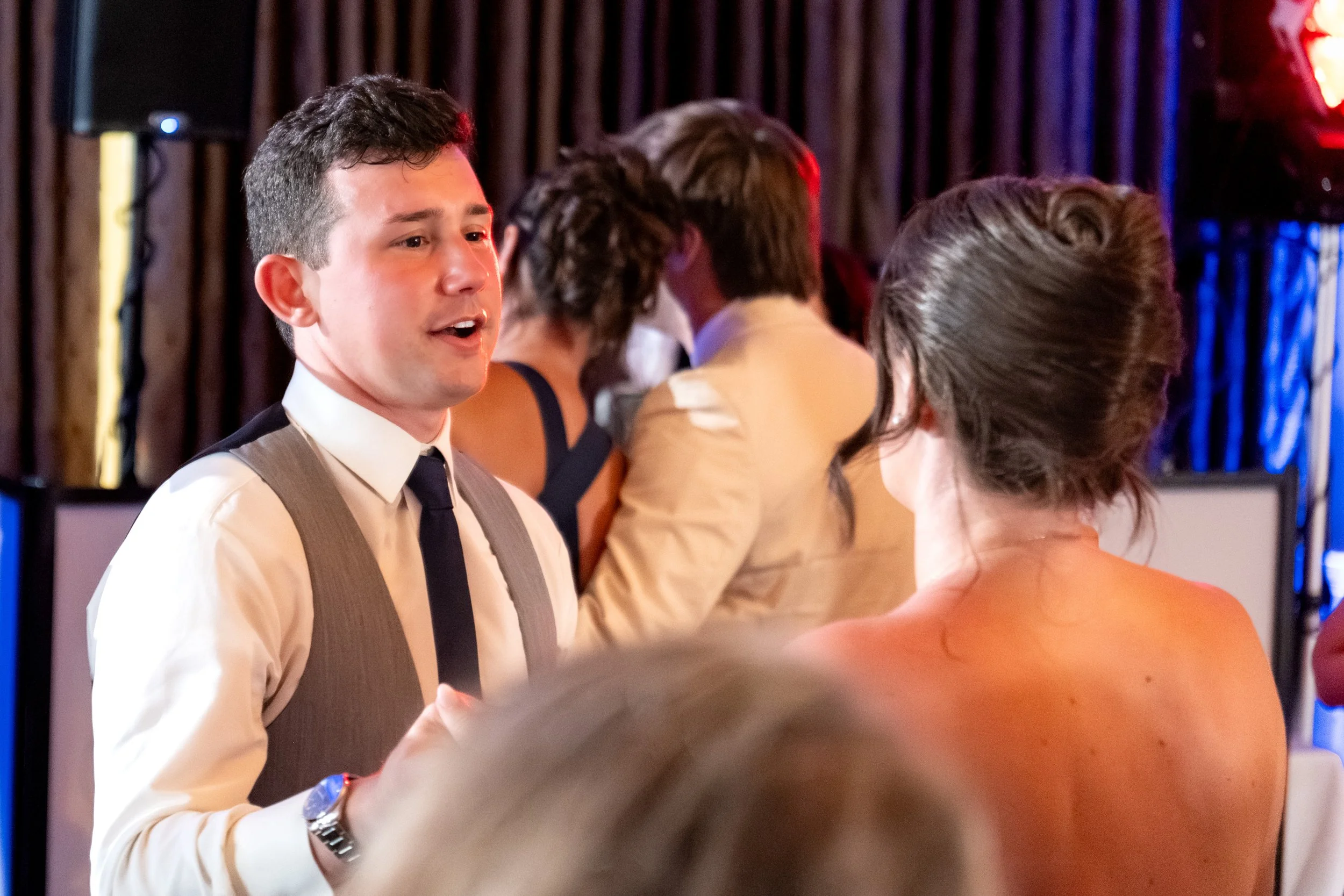 Anthony Pirolli in his vest dancing with a guest on the packed floor at Union Bluff Hotel in York Maine wedding photography VMG Productions