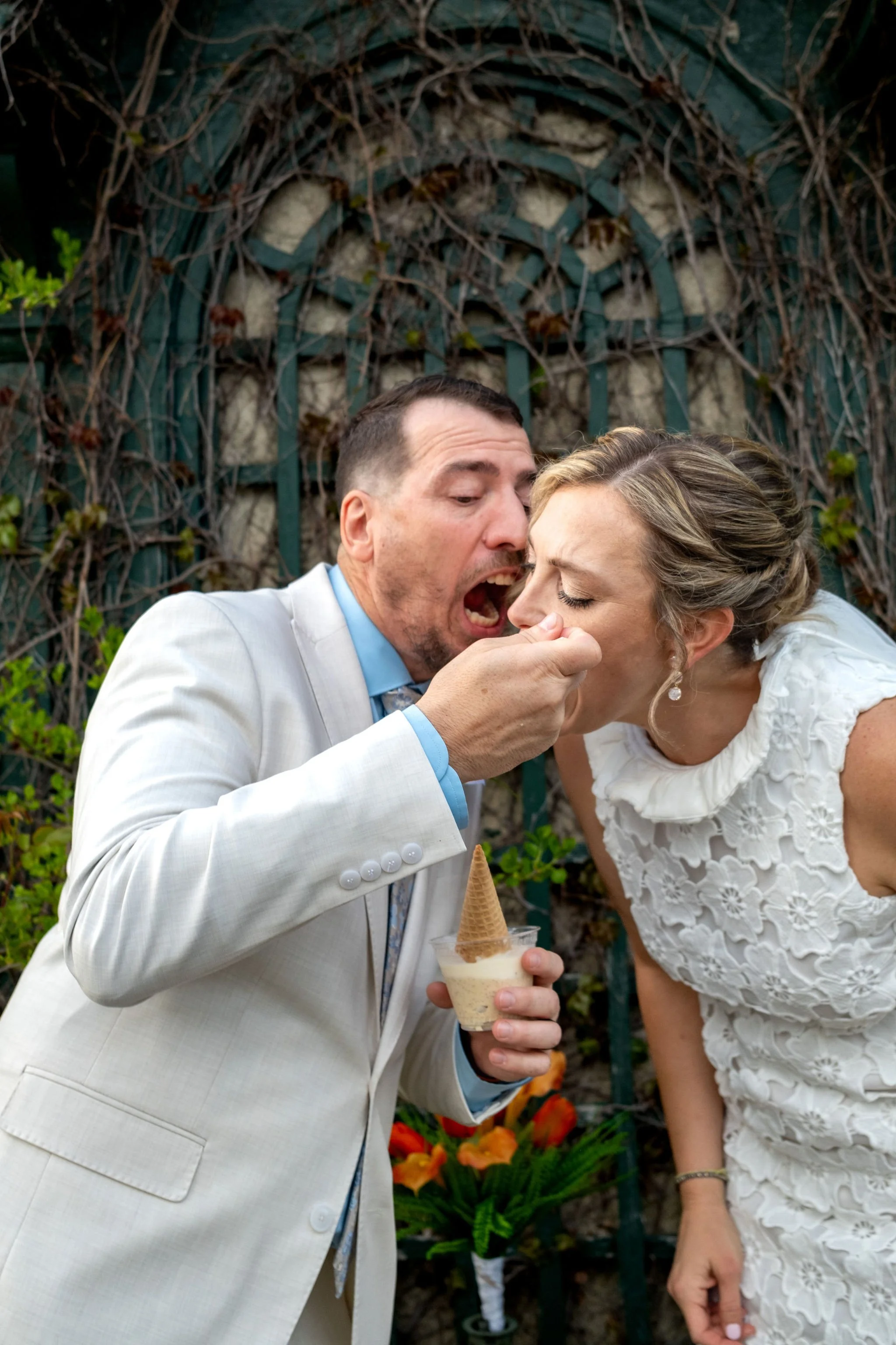 Adam Baudoin kissing Alli's cheek by the ivy trellis in Bar Harbor Maine during their spring wedding photography VMG Productions