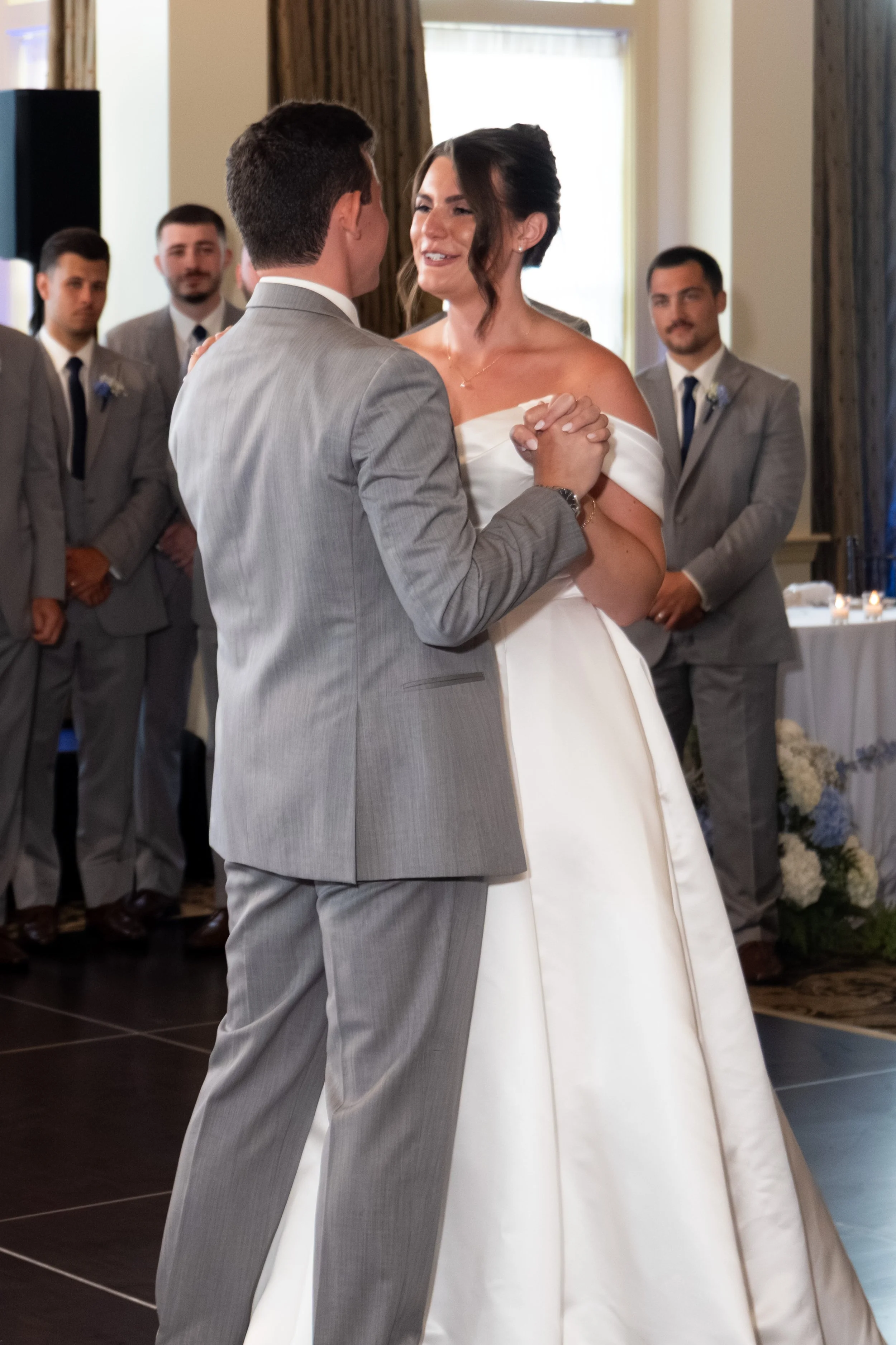 Caroline Pirolli smiling at Anthony with their hands clasped during the first dance at Union Bluff Hotel in York Maine wedding photography VMG Productions